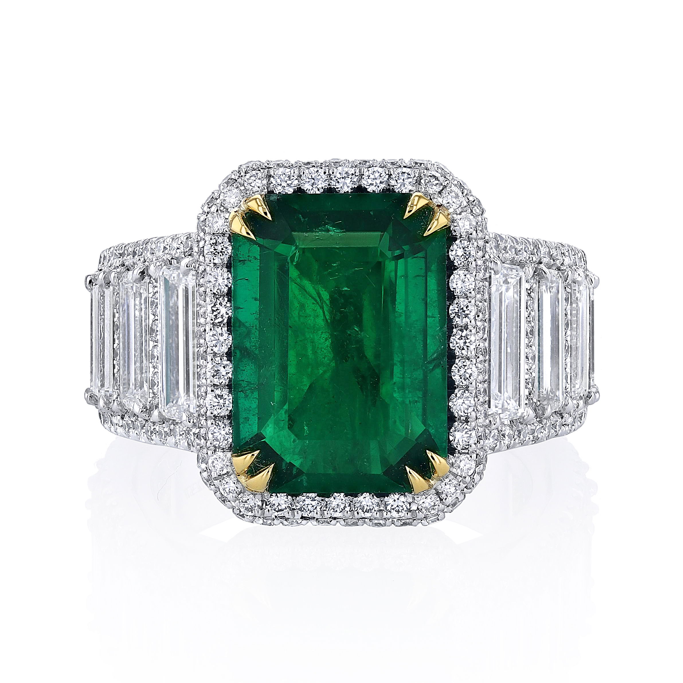 Make a bold statement with this stunning ring, featuring a vibrant natural emerald at its center. A unique setting adorned with various-shaped diamonds enhances its sparkle and sophistication. Crafted for those who appreciate timeless elegance with a modern twist, this ring is a true showstopper.-Platinum & 18k Yellow gold-Emerald, 4.83cts-Round & Baguette Diamonds, 2.71cts-Size 6.25, Contact for sizing optionsItem #: 200-01117 Emerald Cocktail Ring