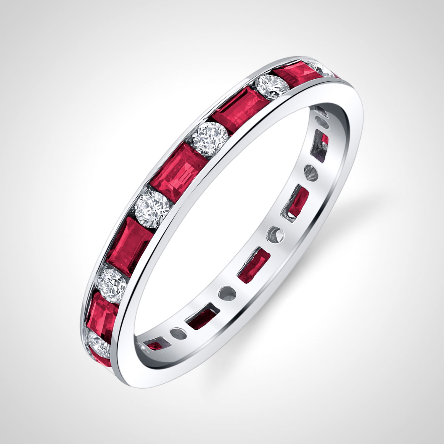A perfect band to wear alone, or stack with other pieces! Adorned with baguette rubies and round diamonds, this piece is promised to impress.-18K White gold-Baguette rubies, 1.05cts-Round diamonds, 0.35cts -Size 6, Contact for sizing optionsItem# 200-01149 Ruby & Diamond Eternity Band