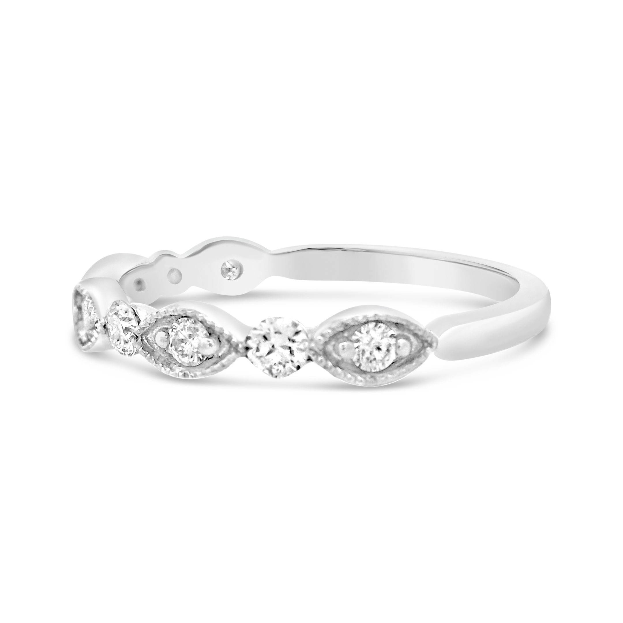 Timeless and versatile, this 18k white gold wedding band features delicate milgrain detailing, adding a touch of vintage charm. Perfect for wearing alone, as a wedding band, or stacked with other rings, its elegant design offers both brilliance and sophistication. -18k White gold-Round diamonds, 0.30cts-Size 6.5, Contact for sizing optionsItem# 110-00579 Milgrain Wedding Band