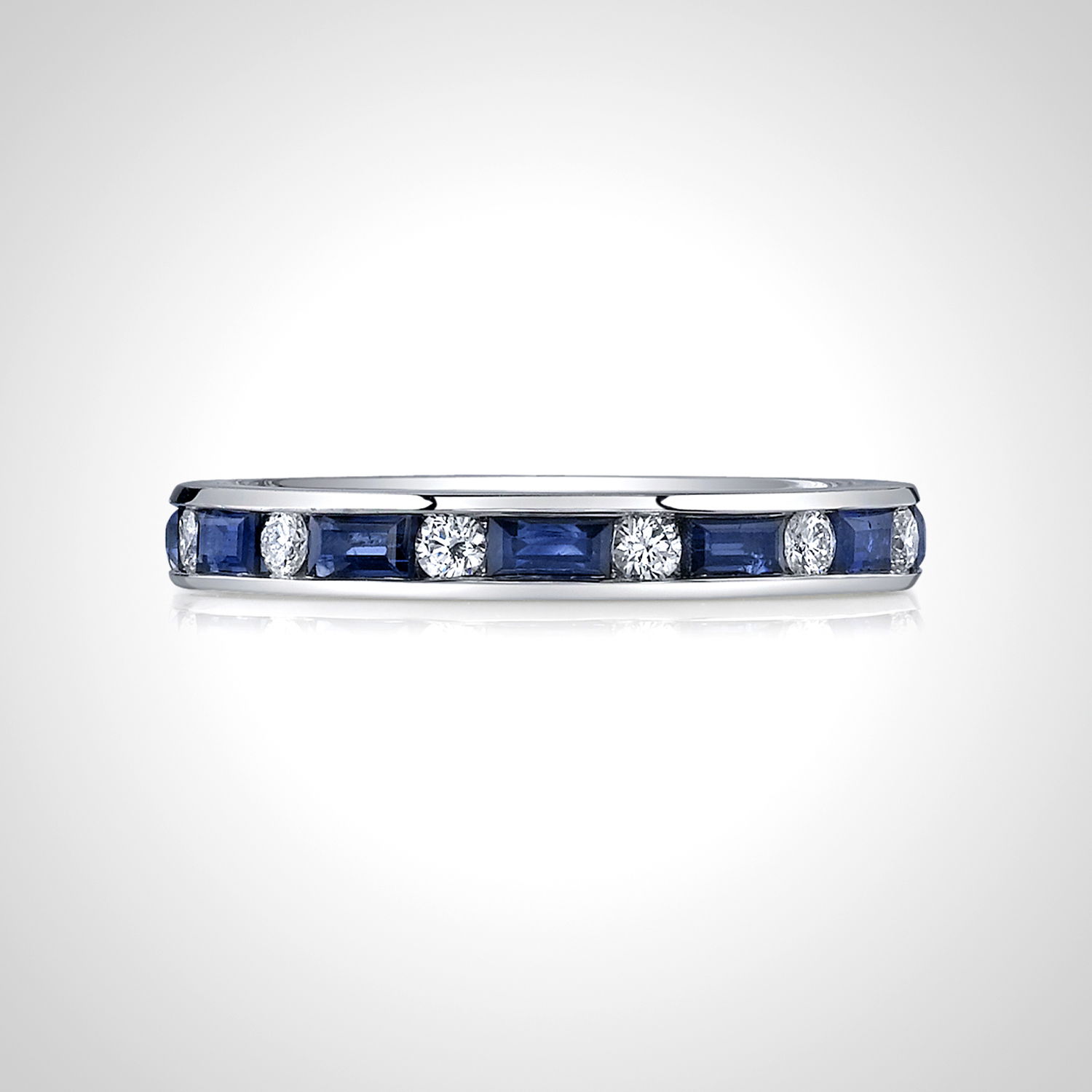 This eternity band features a stunning alternation of diamonds and blue sapphire baguettes, creating a striking and vibrant contrast. A perfect blend of elegance and color, this timeless piece is an exceptional symbol of lasting love.-18k White gold-Round Diamonds, 0.39cts-Baguette Blue Sapphires, 1.30cts-Size 6, Contact for sizing optionsItem #: 110-00648 Diamond & Sapphire Eternity Band