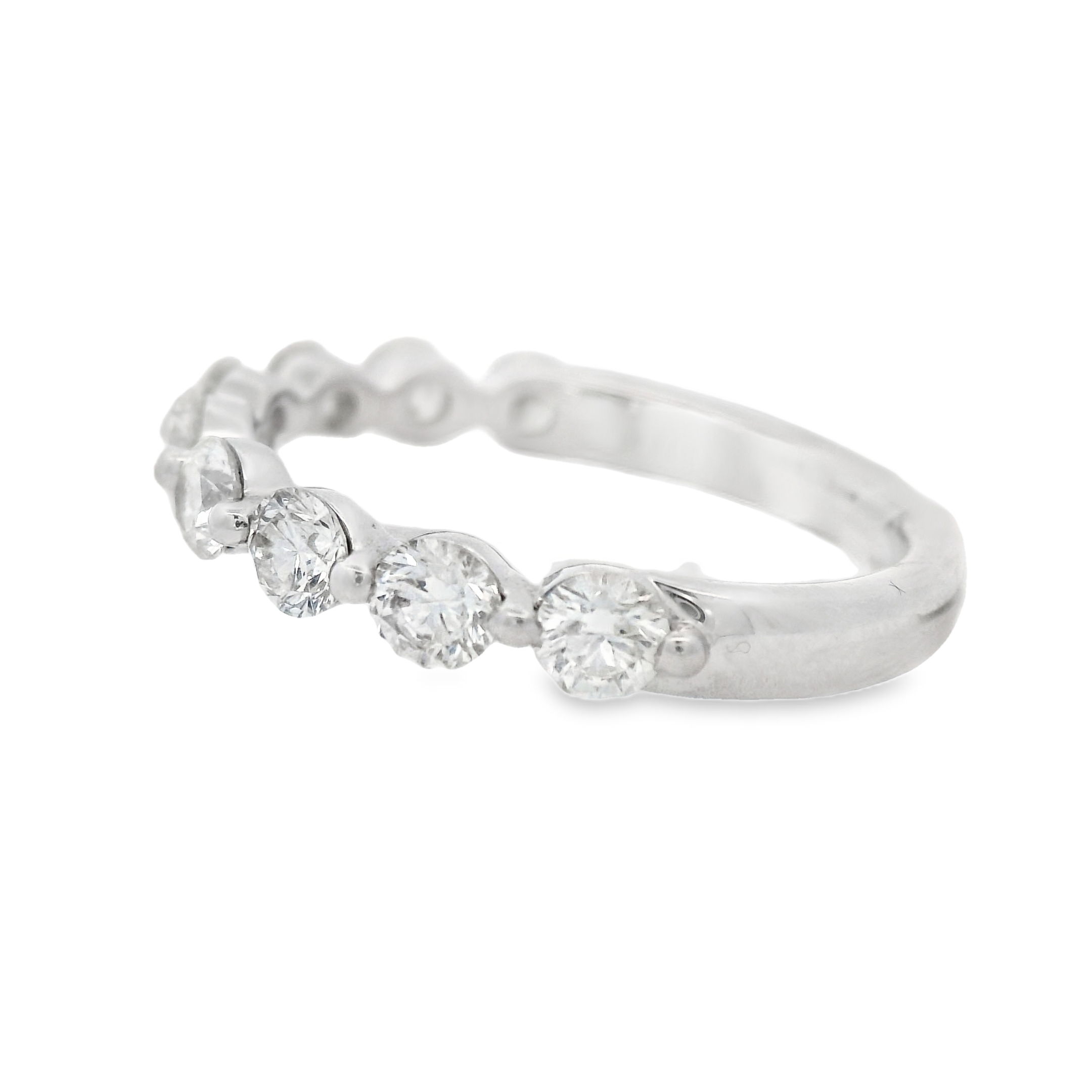 Elegant and timeless, this 18k white gold diamond wedding band features a single shared prong setting, allowing maximum brilliance and a seamless flow of sparkle. Designed for versatility, it pairs beautifully with an engagement ring or stands out on its own. A perfect blend of sophistication and modern elegance.-18k White gold-Round diamonds, 1.00cts-Size 6.5, Contact for sizing optionsItem# 110-00652 Shared Prong Wedding Band