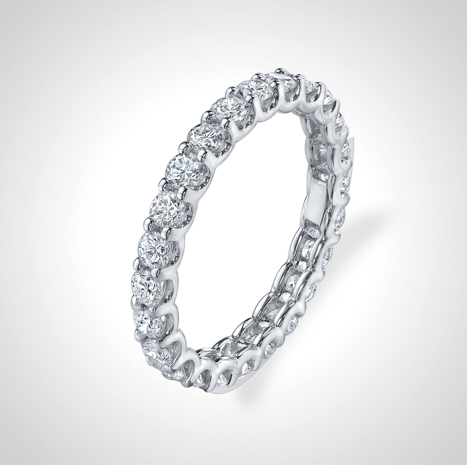 This eternity anniversary band features round diamonds set in a unique "U" setting, enhancing their brilliance and creating a timeless, elegant look. A perfect way to celebrate your love, this band adds sophistication and sparkle to any occasion.-18k White gold-Round Diamonds, 1.52cts-Size 6, Contact for sizing optionsItem #: 120-00028 U-Basket Eternity Band