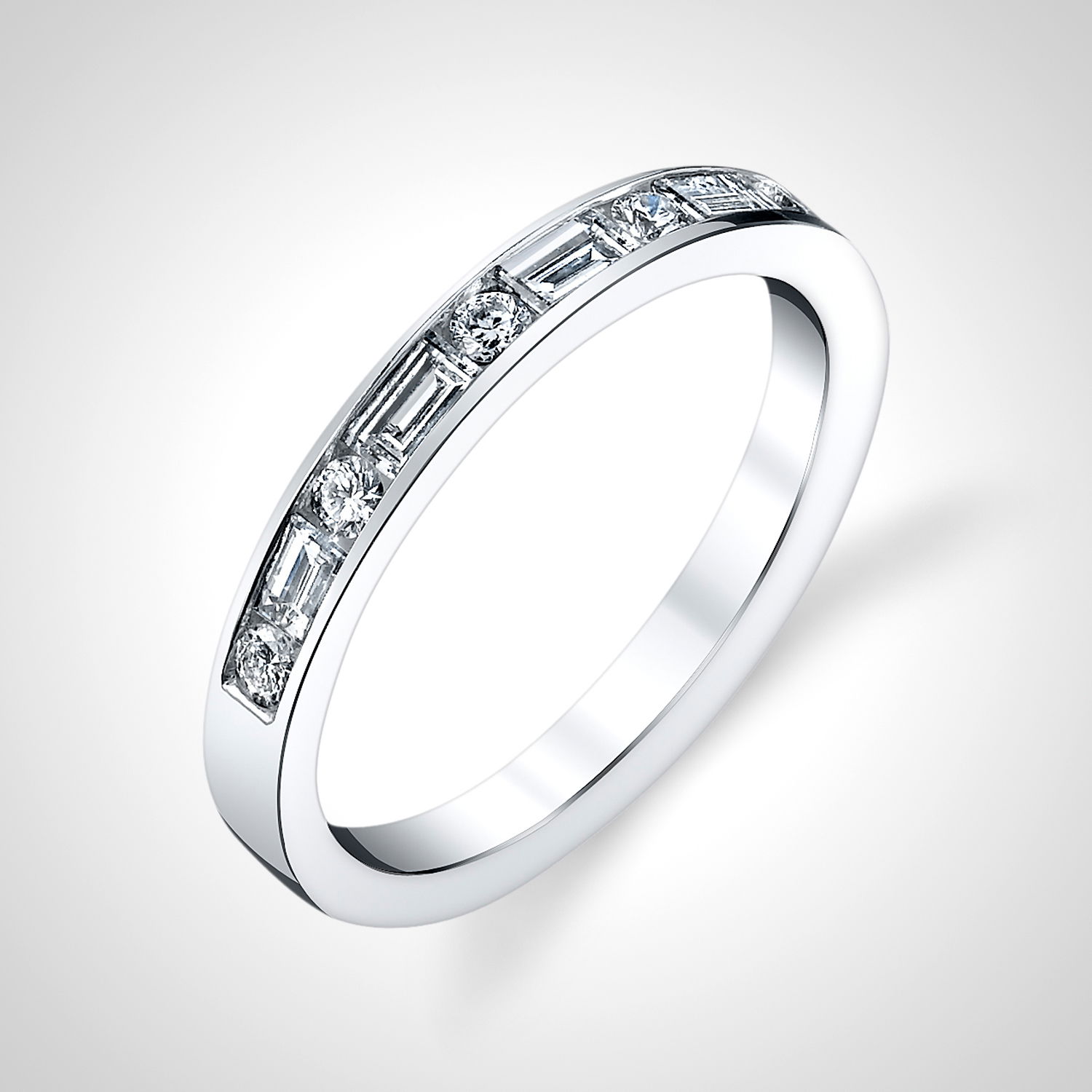 This 1/2-way band features alternating channel-set baguette and round diamonds, creating a balanced and sophisticated design. Its timeless elegance makes it a perfect choice for any occasion, offering a stunning blend of sparkle and style.-18k White gold-Round and baguette diamonds, 0.84cts-Size 6.5, Contact for sizing optionsItem# 120-00121 Baguette & Round Wedding Band