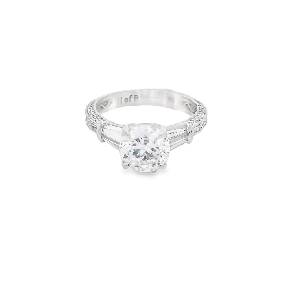 Designed for timeless elegance, this 18k White gold semi-mount features tapered baguette diamonds that gracefully flank the center stone of your choice. The sleek baguettes add a refined touch, enhancing the brilliance of the centerpiece while creating a sophisticated, balanced look. (Center stone not included)-18k White gold-Baguette diamonds, 0.57cts-Round diamonds, 0.30cts-Size 6.5, Contact for sizing optionsItem# 140-00003 Baguette Mounting