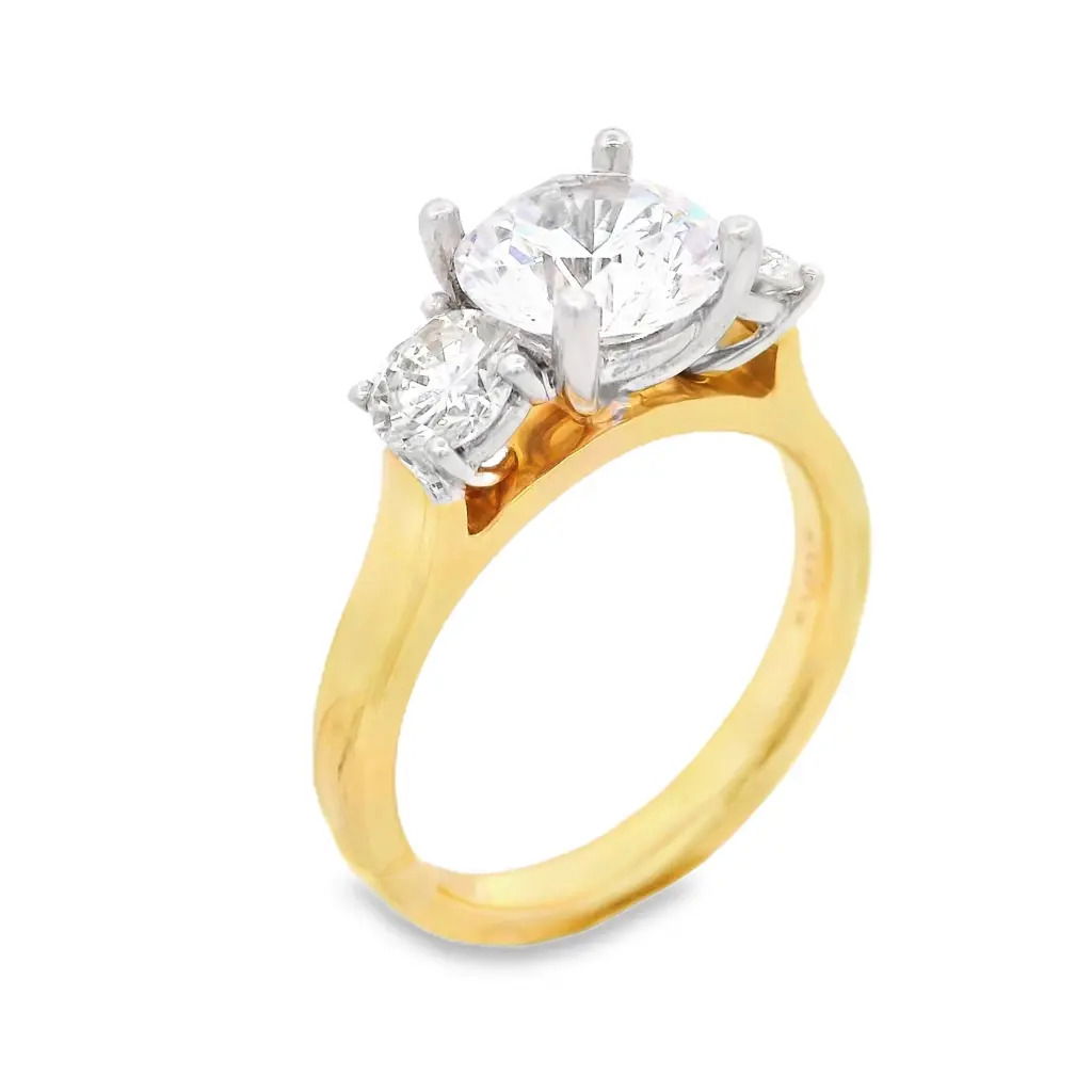 This three-stone setting was crafted for brilliance and durability. It is perfect for showcasing your chosen diamond or gemstone in a truly radiant way. It includes two round diamonds weighing a total of 0.66cts. (Center stone not included)-18k Yellow and white gold-Round diamonds, 0.66cts-Size 6, Contact for sizing optionsItem# 140-00160 Margot
