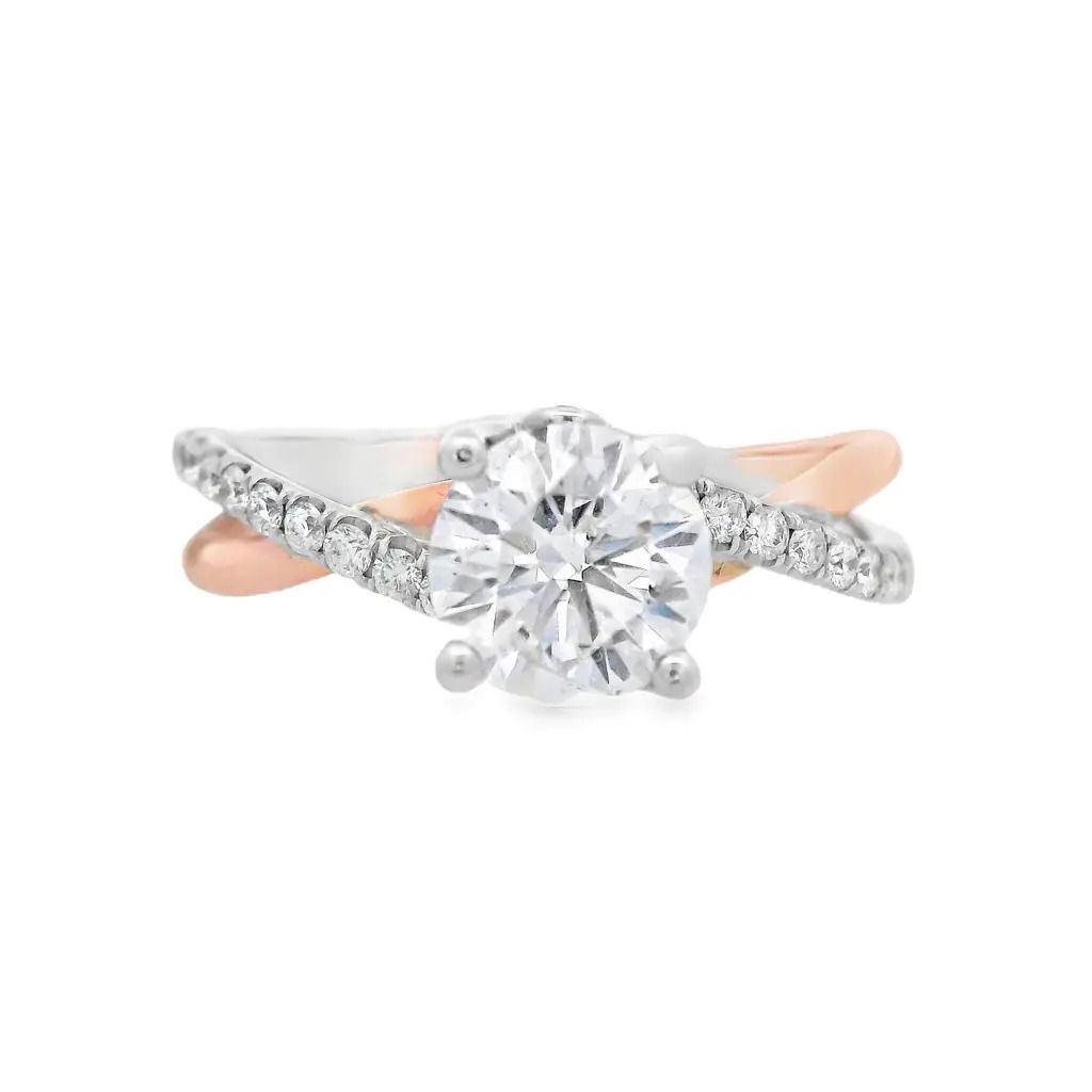 This two-toned semi mount effortlessly blends two metals, creating a striking contrast that enhances the beauty of your chosen center stone. The twisted design features delicate detailing, offering both modern appeal and timeless elegance. (Center diamond sold separately)-14k Rose and White gold-Round diamond, 1.01ct (sold separately)-Round diamonds, 0.20cts-Size 6.5, Contact for sizing optionsItem# 140-00164 Round 1.01ct Twisted Engagement