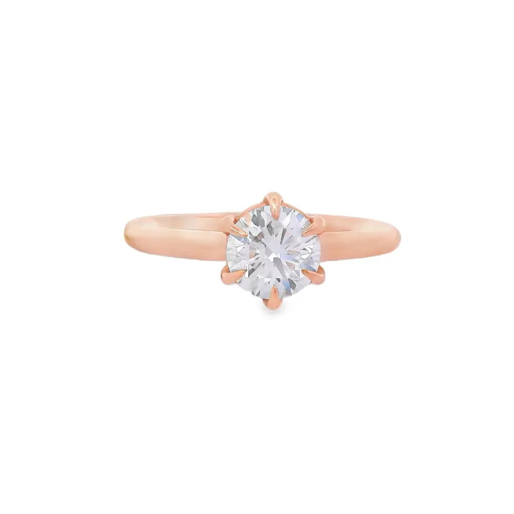 Timeless and refined, this six-prong 14k Rose gold solitaire engagement ring offers a classic setting that highlights the brilliance of your center stone. The sleek design draws all eyes to the diamond, making it a perfect choice for those who appreciate understated elegance with lasting style. (Center diamond sold separately)-14k Rose gold-Round diamond, 0.90ct (sold separately)-Size 6.5, Contact for sizing optionsItem# 140-00165 Round 0.90ct Rose Gold Engagement