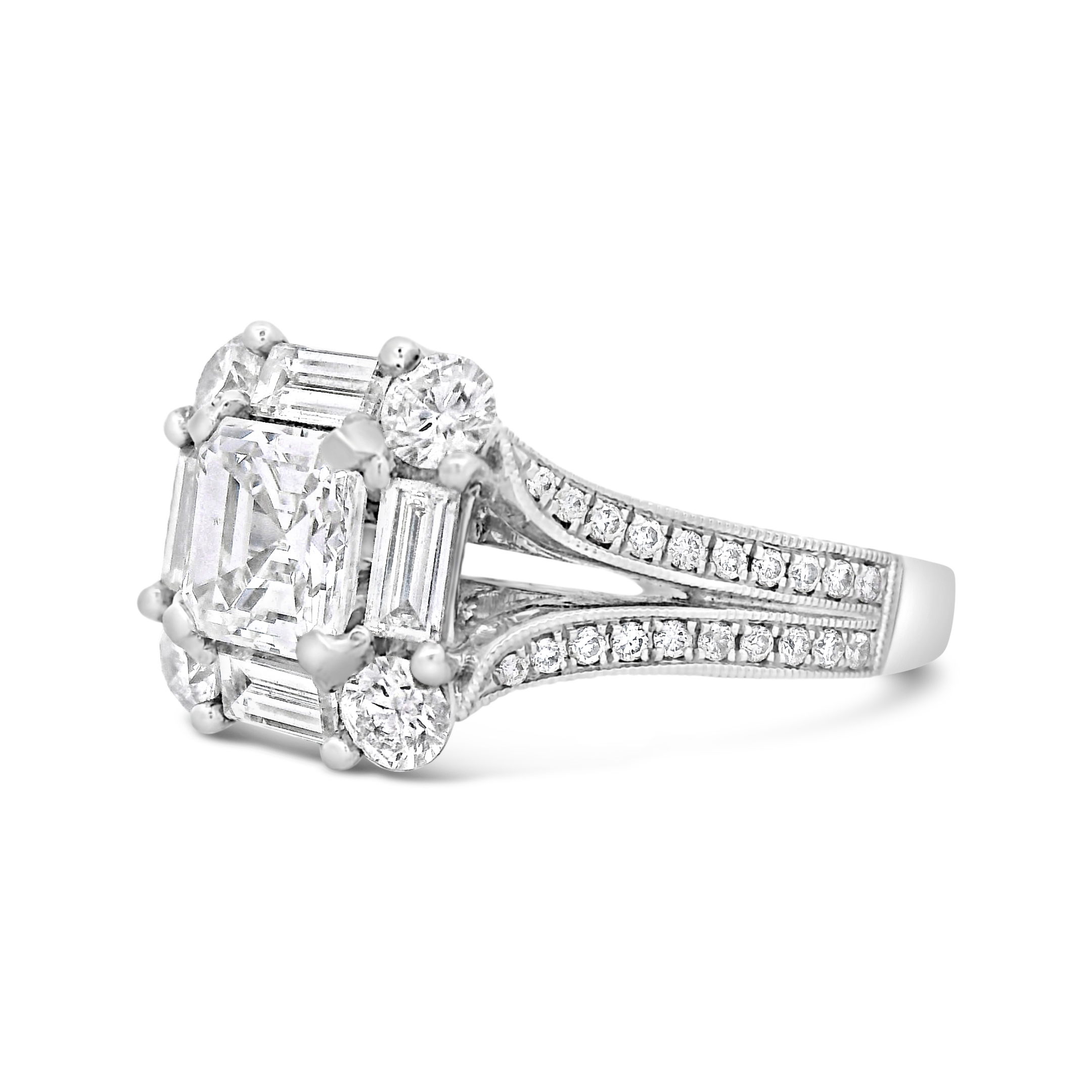 This halo and split shank semi mount combines classic elegance with modern design. The diamond halo encircles your center stone, adding a brilliant sparkle, while the split shank enhances the overall structure and adds a touch of sophistication. Center diamond sold separately-18k White gold-Asscher diamond, 1.04cts (sold separately)-Baguette diamonds, 0.53cts-Round diamonds, 0.68cts-Size 6.5, Contact for sizing optionsItem# 140-00176 Multi-Stone Engagement Ring