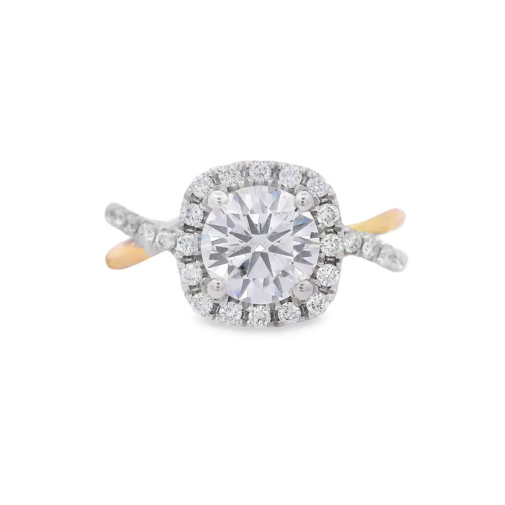 This two-toned diamond semi mount is a striking blend of elegance and modern design. Featuring a brilliant halo of diamonds surrounding your chosen center stone, it adds radiance from every angle. The twisted shank, adorned with delicate diamonds, enhances the ring's sophisticated look. (Center diamond sold separately)-14k Yellow and White gold-Round diamonds, 0.35cts-Size 6.5, Contact for sizing optionsItem# 140-00180 Twisted Two-Tone Mounting
