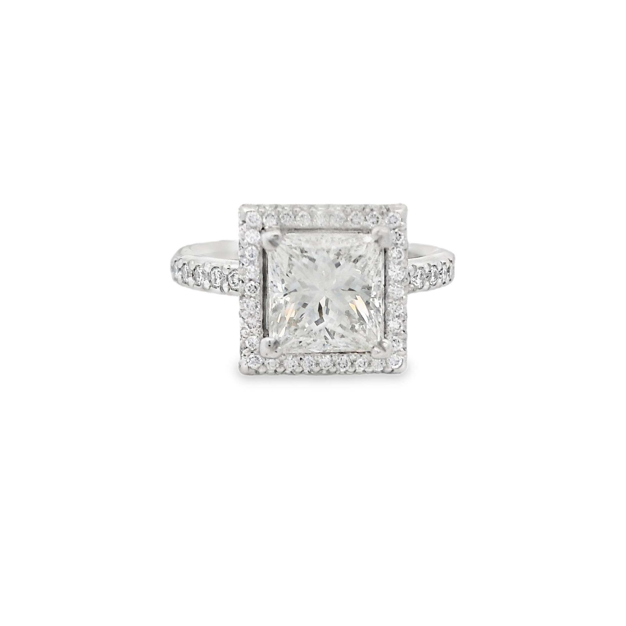 This stunning platinum engagement ring features a striking princess cut center diamond, framed by two delicate halos of sparkling diamonds. The double halo enhances the center stone's brilliance and size, creating a bold yet elegant look. (Center diamond sold separately)-Platinum-Round diamonds, 0.78cts-Size 5.75, Contact for sizing optionsItem# 140-00211 Halo Engagement Ring