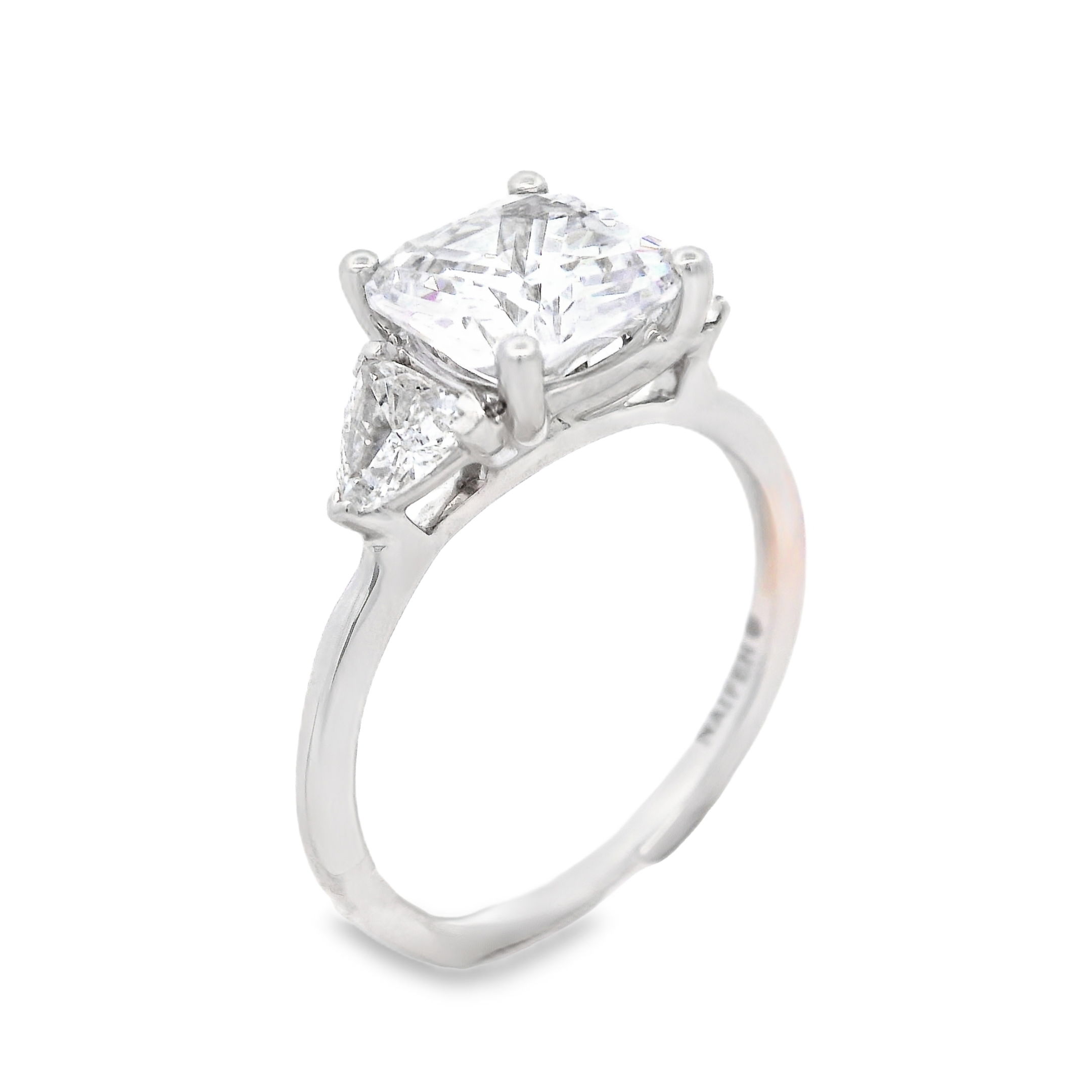 This elegant three-stone style semi-mount in 18k White gold features striking trillion side diamonds that perfectly complement your chosen center stone. The unique shape of the side diamonds enhances the overall design, adding modern sophistication and timeless beauty. (Center stone not included)-18k White gold-Trillion diamonds, 0.40cts-Size 6.5, Contact for sizing optionsItem# 140-00220 Cushion & Trillion Three-Stone Mounting