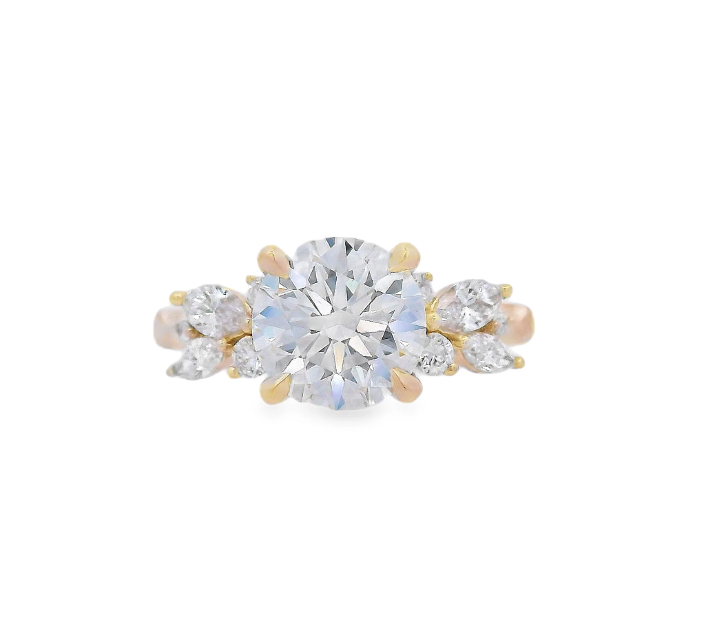 This beautiful 18k Yellow gold semi-mount features round and marquise side diamonds arranged in a floral-like shape, adding a touch of elegance and whimsy to your chosen center stone. The unique diamond arrangement creates a timeless, feminine design, making this setting a perfect choice for the romantic and sophisticated bride. (Center stone not included)-18k Yellow gold-Round, Marquise diamonds, 0.28cts-Size 6.5, Contact for sizing optionsItem# 140-00277 Floral Inspired Semi-Mount