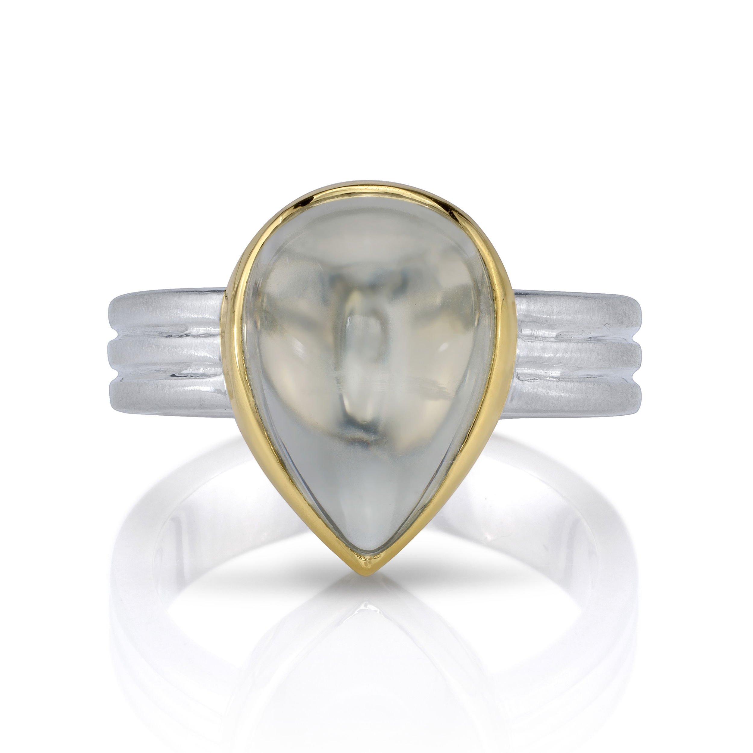 This mesmerizing moonstone ring features a cloudy green stone set in a yellow gold setting, paired with a contrasting silver band. The design highlights the natural beauty of the moonstone, giving it a unique and captivating look.-18k Yellow gold-Sterling silver-Pear shape green moonstoneItem# 804-00863 Nova Ring