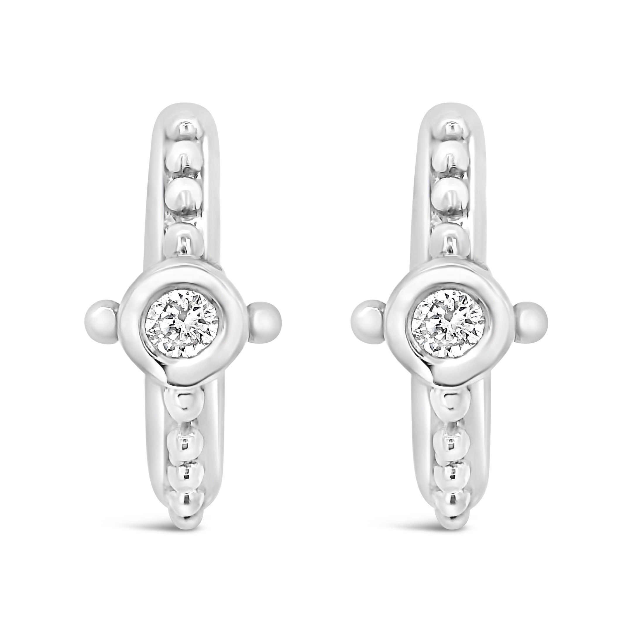 These 18k white gold huggie earrings showcase bezel-set diamonds for a clean, timeless look. Effortless and versatile, they add just the right touch of sparkle for any occasion.-18k White gold-Diamonds, 0.14ctsItem# 001-805-01398 Tatiana Huggie Earrings