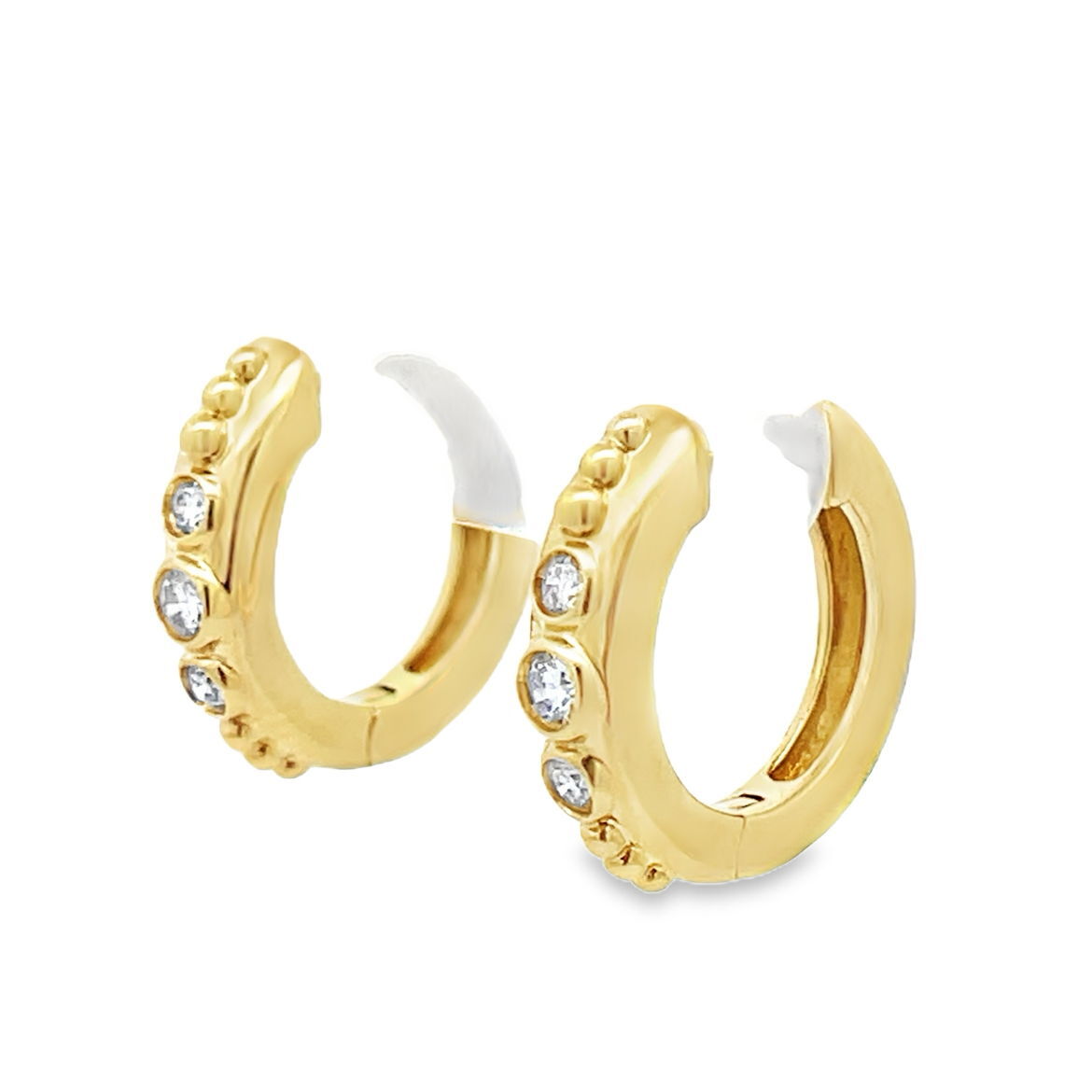 These 18k yellow gold huggie earrings feature bezel-set diamonds for a sleek, modern look. Comfortable and versatile, they’re the perfect everyday sparkle you’ll never want to take off.-18k Yellow gold-Diamonds, 0.19ctsItem# 001-805-01555 Odessa Huggie Earrings