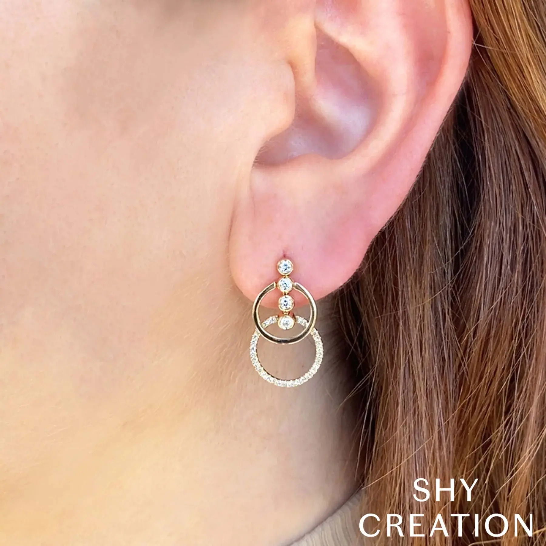 Stand out effortlessly with a design that turns heads at any event, making you the center of attention. All Shy Creation diamonds are natural and hand-selected. All stones are unique and hand set. As a result, you can expect slight variations in the shade, hue, tint of the color stones and stone count.-14k Yellow gold-Round diamonds, 0.22cts-Round diamonds, 0.17cts-Dimensions, 0.85"L / 0.50"WItem# 805-01583 Diamond Bezel Circle Earrings