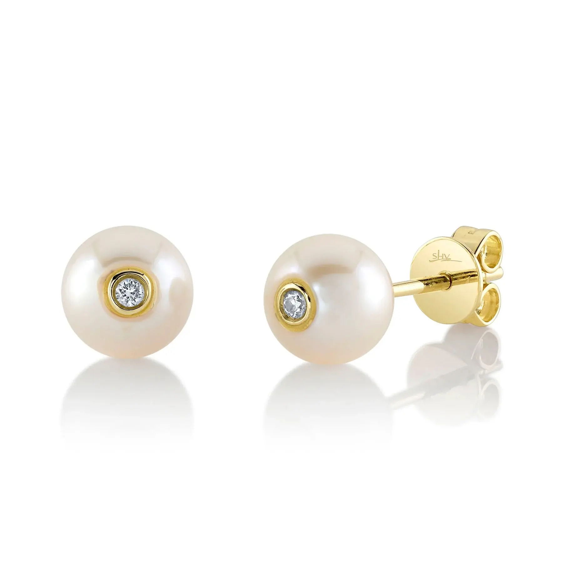 This versatile piece effortlessly transitions from day to night, adding subtle elegance to every moment. All Shy Creation diamonds are natural and hand-selected. All stones are unique and hand set. As a result, you can expect slight variations in the shade, hue, tint of the color stones and stone count.-14k Yellow gold-Round pearls, 7.1-7.5mm -Round diamonds, 0.04ctsItem# 805-01584 Diamond and Cultured Pearl Stud Earrings