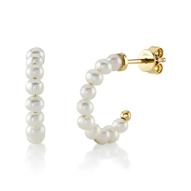 Delicate and feminine, these small hoops by Shy Creation feature timeless pearls with a yellow gold back. A lightweight style perfect for an elegant ensemble. -14k Yellow gold-Round pearlsItem# 805-01772 Small Pearl Hoop