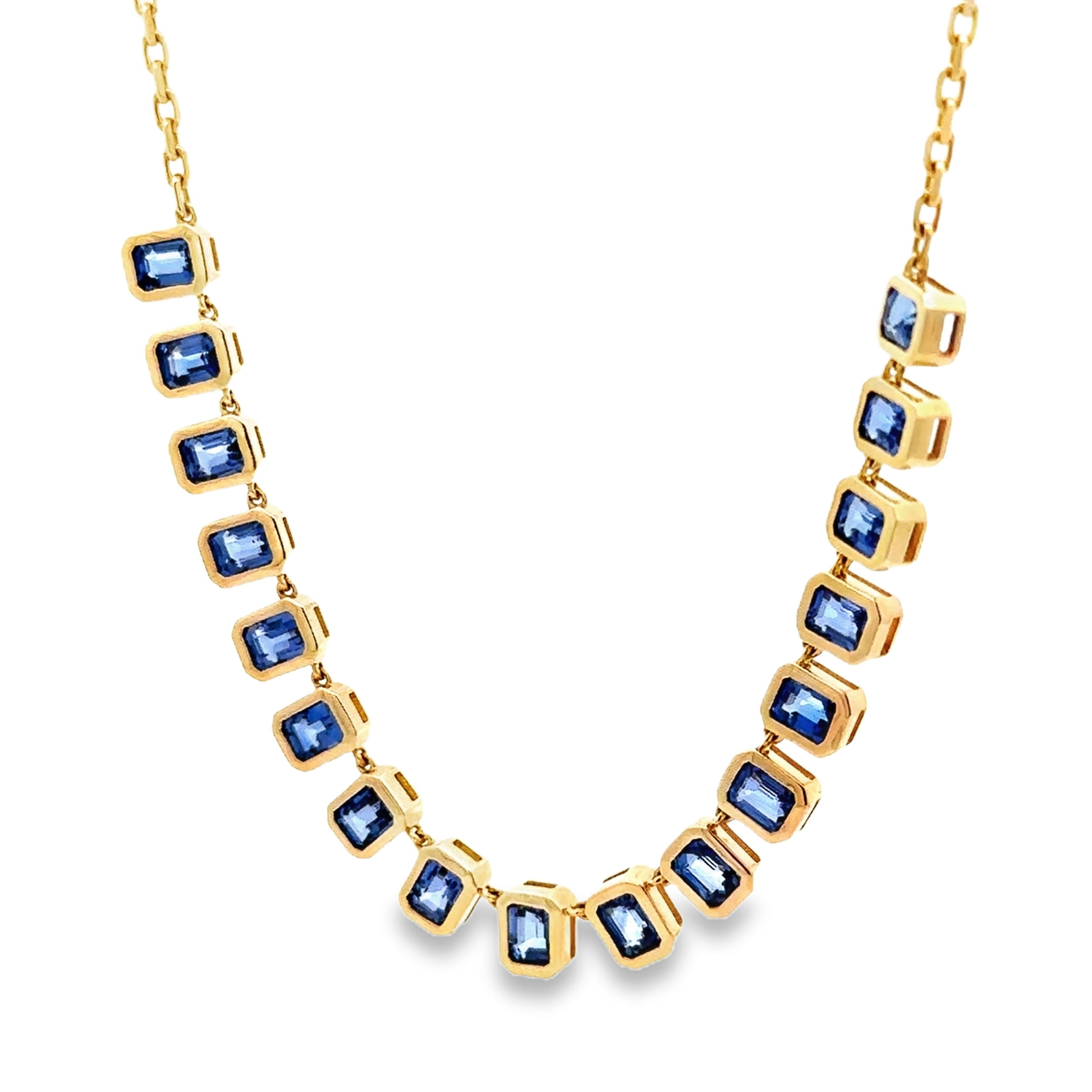 This necklace showcases a collection of rectangular sapphires set in elegant gold settings. The arrangement of these vibrant stones creates a bold and sophisticated design, perfect for adding a pop of color and refinement to any look.-14k Yellow gold-Rectangular blue sapphires, 6.32ctsItem# 807-01097 Blue Sapphire Necklace