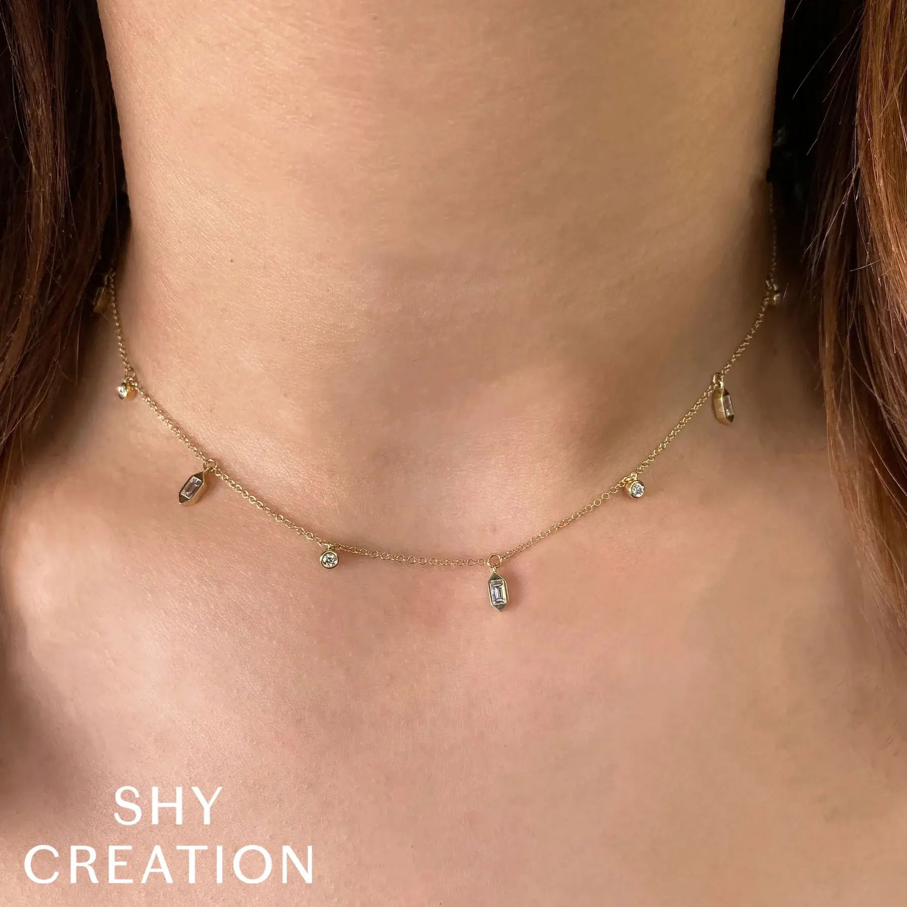 Experience both luxury and comfort with this timeless piece, designed for everyday elegance. All Shy Creation diamonds are natural and hand-selected. All stones are unique and hand set. As a result, you can expect slight variations in the shade, hue, tint of the color stones and stone count.-14k Yellow gold-Round diamonds, 0.15cts-Baguette diamonds, 0.23cts-Chain length, 15"-18"Item# 807-01134 Diamond Baguette Bezel Necklace