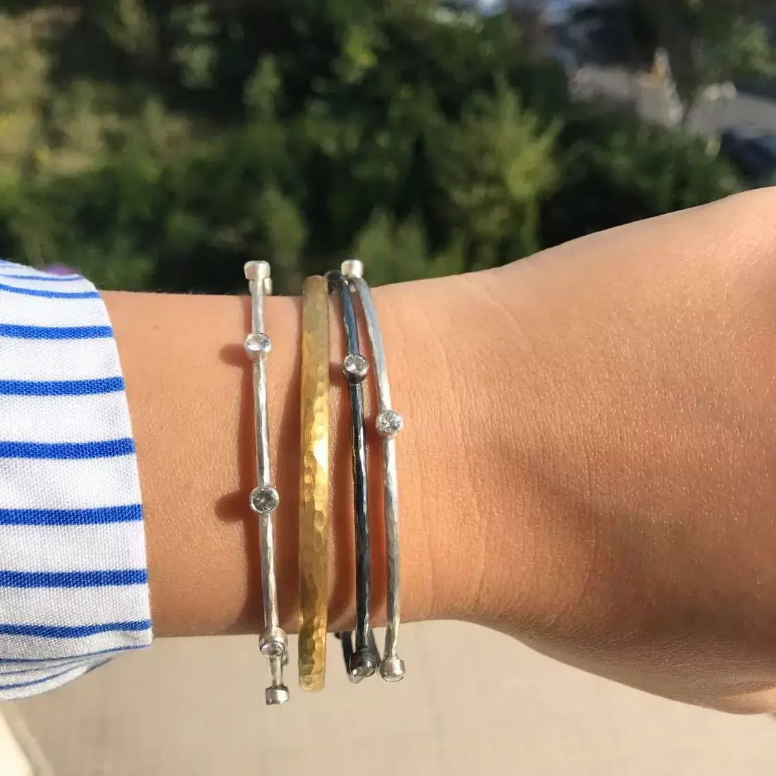 Crafted from sterling silver and fused with luxurious 24k gold, this bangle bracelet offers a timeless blend of elegance and durability. Shop now to elevate your everyday style with a piece that stands out effortlessly.-24k Gold and oxidized silver-4mm width-Size 7 Item# 001-808-00007 Gold Bangle Bracelet