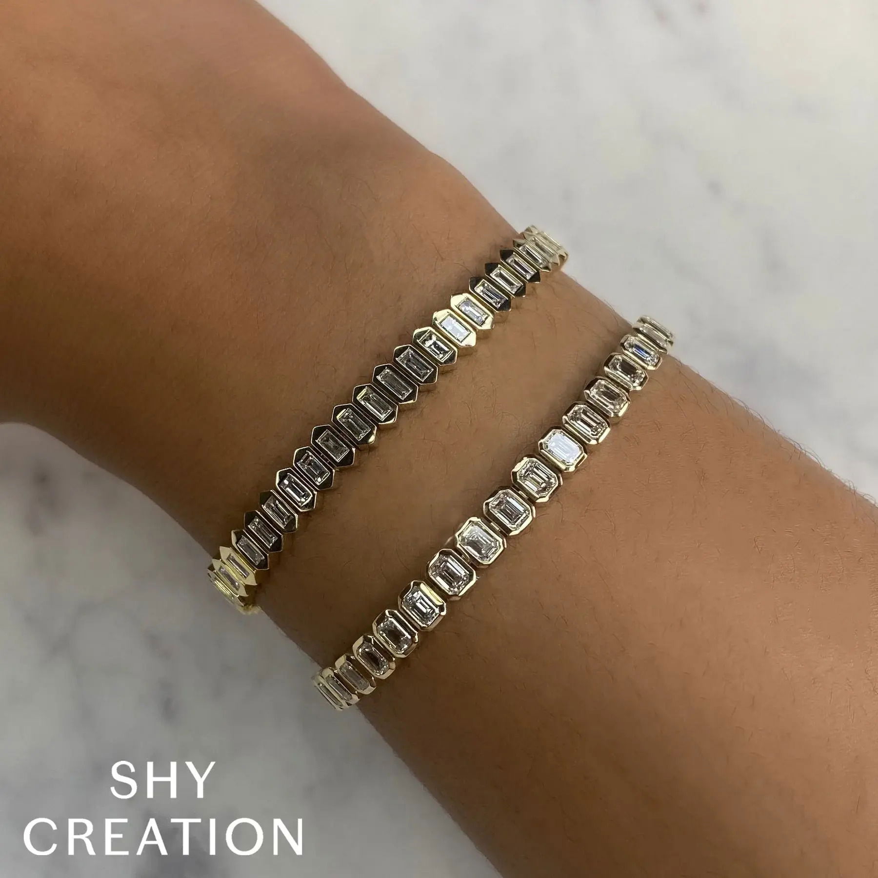 Whether worn solo or stacked, this piece makes a beautiful addition to any collection. All Shy Creation diamonds are natural and hand-selected. All stones are unique and hand set. As a result, you can expect slight variations in the shade, hue, tint of the color stones and stone count.-14k Yellow gold-Baguette diamonds, 1.70cts-Dimensions, 0.20"W-Size SItem# 808-00953 Diamond Baguette Bangle