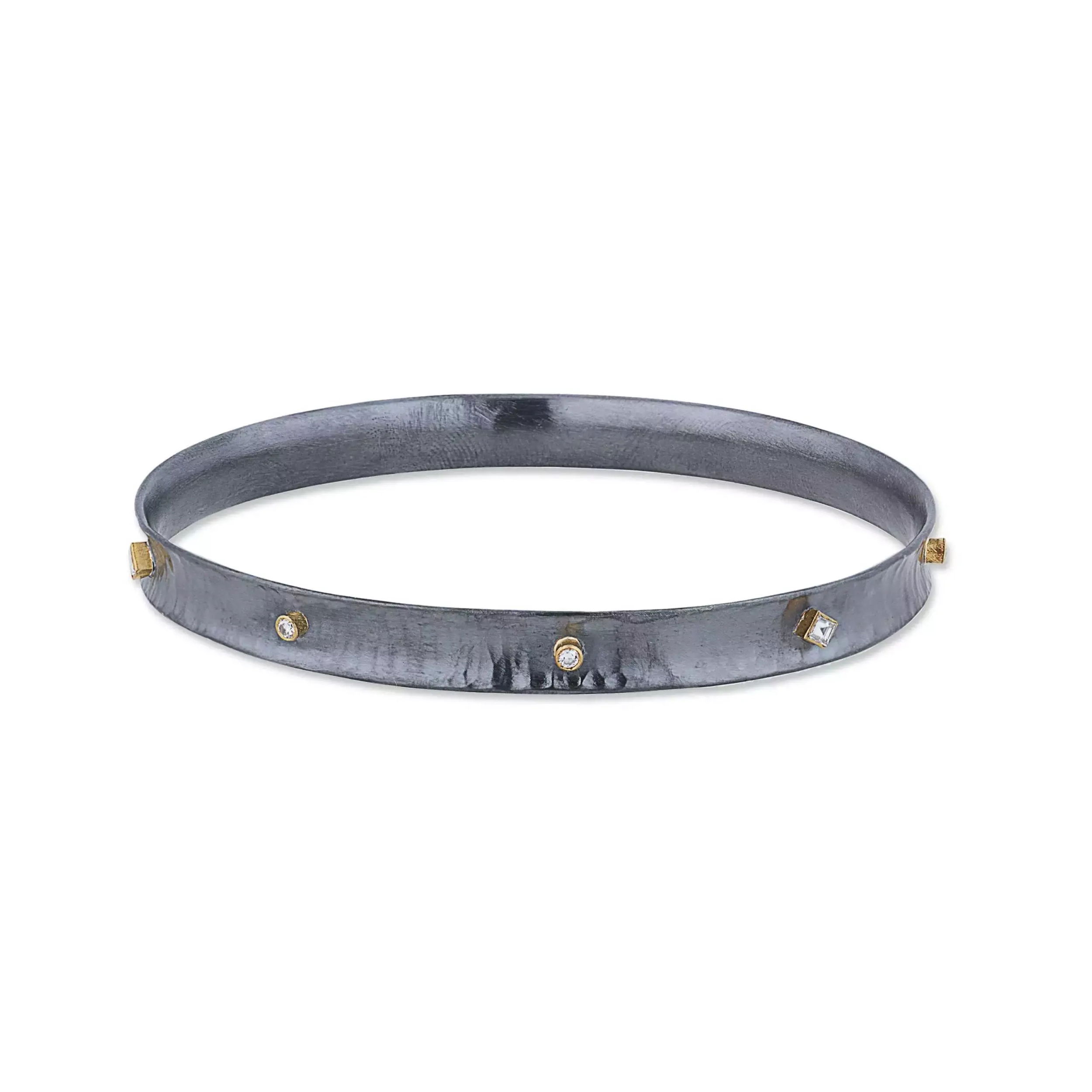 Make a bold statement with the oxidized silver and 24 karat gold "Inversion" bracelet. Featuring an exquisite interplay of round and square step-cut diamonds, this captivating piece is a harmonious blend of modern artistry.-Oxidized silver -24k Yellow gold-Diamonds, 0.24 cts-Size 7Item# 001-808-00978 Inversion Bangle