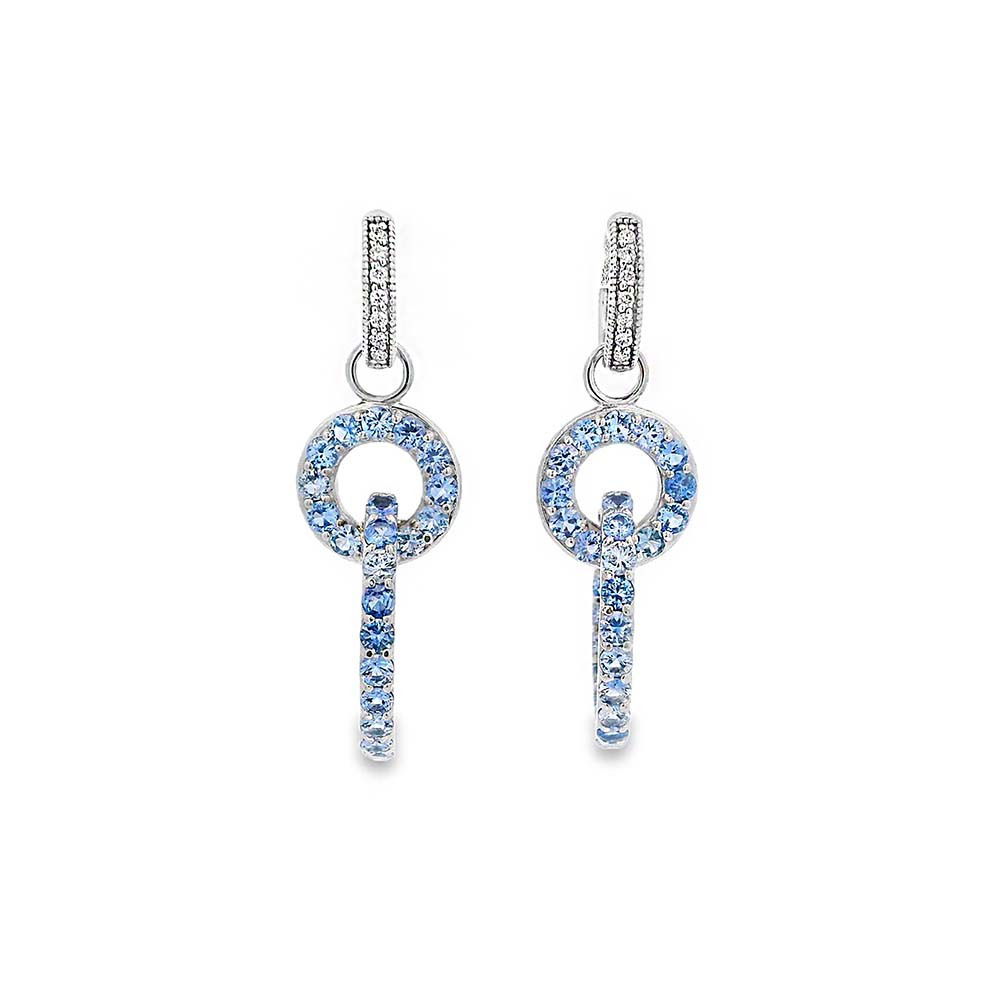 These earrings feature brilliant round sapphires set in 14k white gold, offering a timeless and elegant look. Perfect for adding a subtle pop of color, they bring a touch of sophistication to any occasion. Huggies sold separately.-14k White gold-Round sapphires, 3.30ctsItem# 809-00499 Radiant Rings Earring Charms