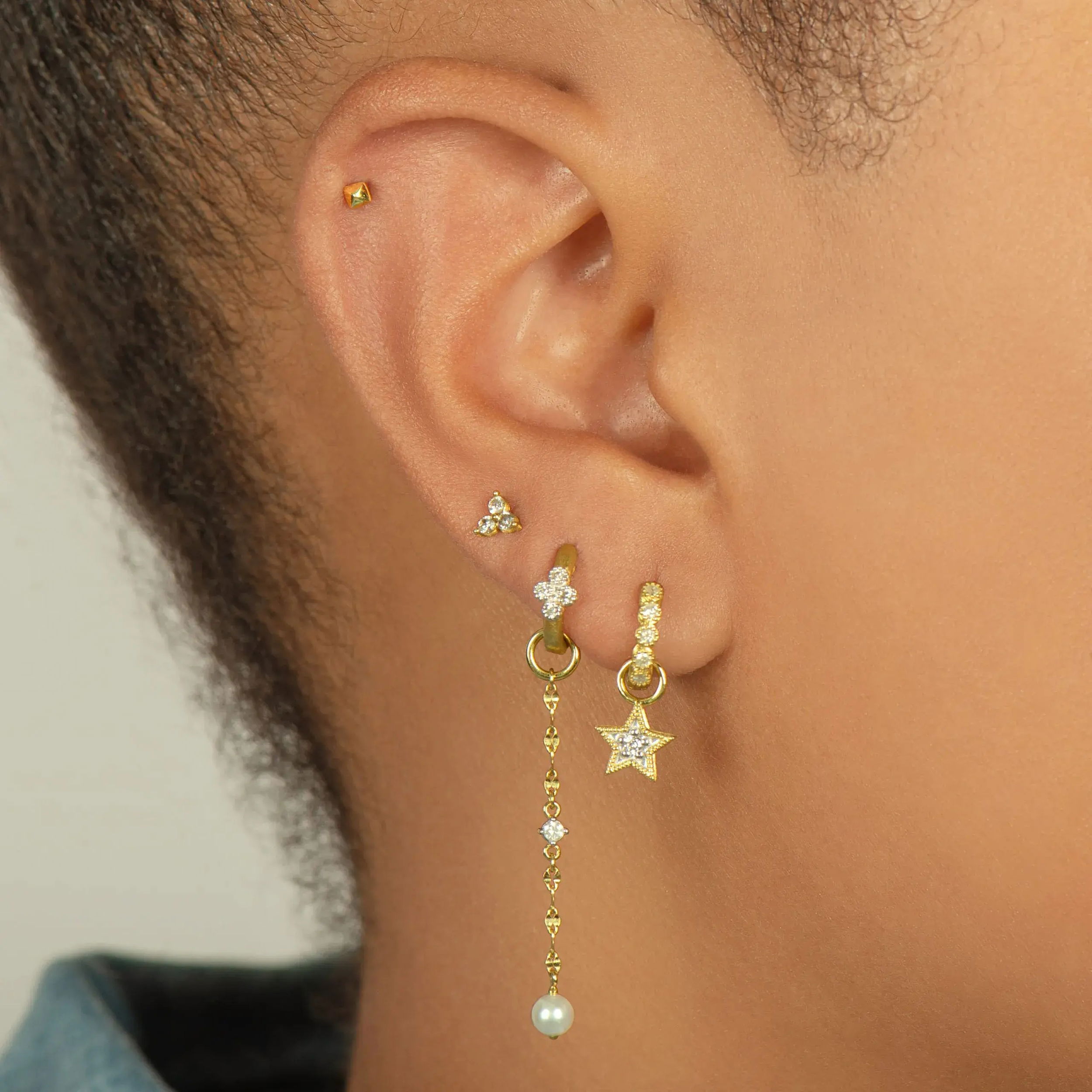 Combining classic elegance with on trend shapes and styles, JFJ offers something for women of all ages. From the Petites Collection, this star charm features a white diamond in the center and 18k yellow gold milgrain detail along the edges. Hoops and charms sold separately. Charms sold as singles.-18k Yellow gold-Round white diamonds, 0.02cts-Dimensions, 7.40mm x 1.40mmItem# 809-00640 Petite Star Earring Charm