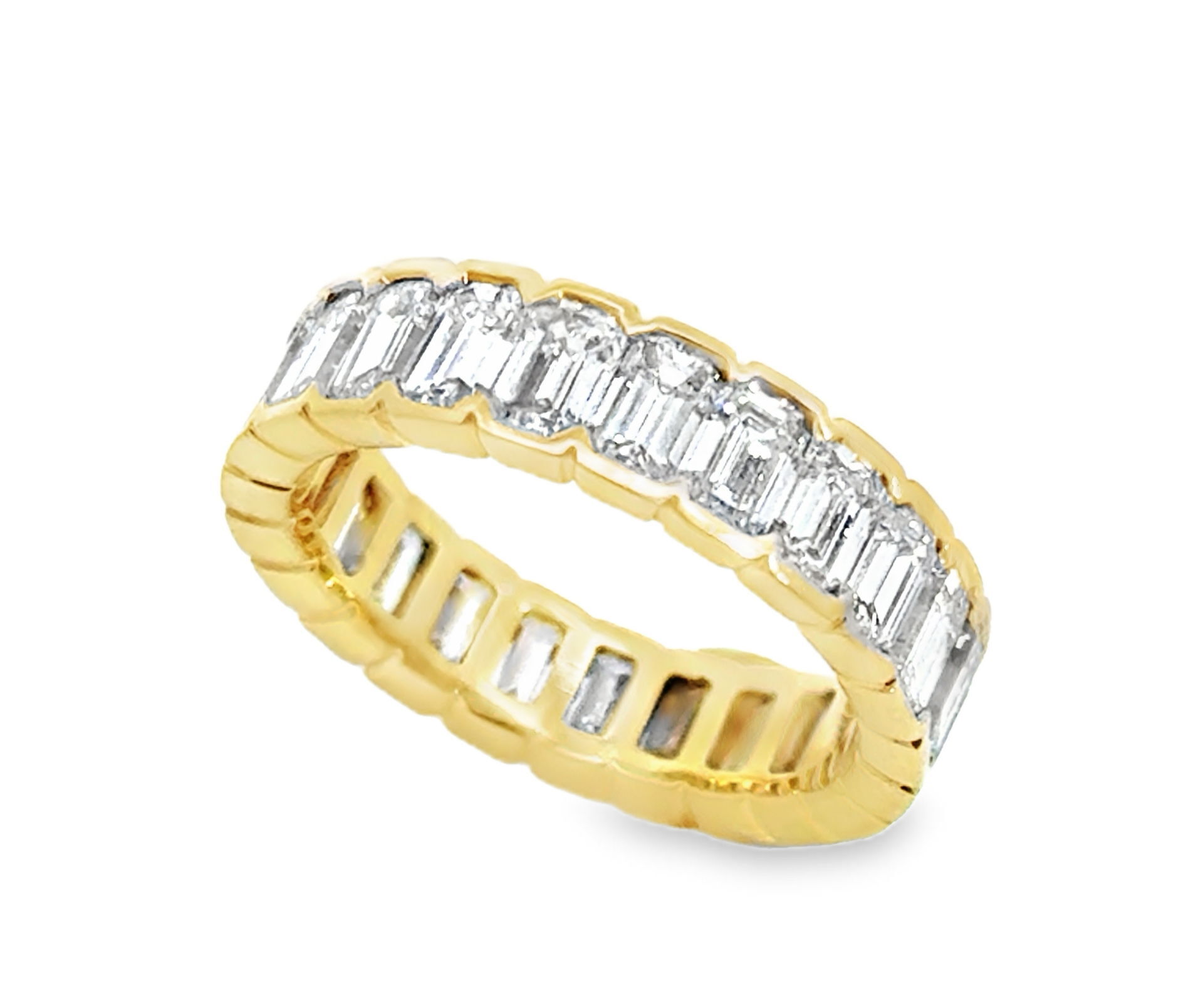 This stunning eternity ring showcases a brilliant emerald-cut diamond, expertly set in warm 18k yellow gold. Its continuous band of diamonds creates a mesmerizing effect, symbolizing everlasting love and beauty.-18k Yellow gold-Diamonds, 4.78cts-Size 6.5Item# 002-120-00178 Emerald Cut Diamond Eternity Band