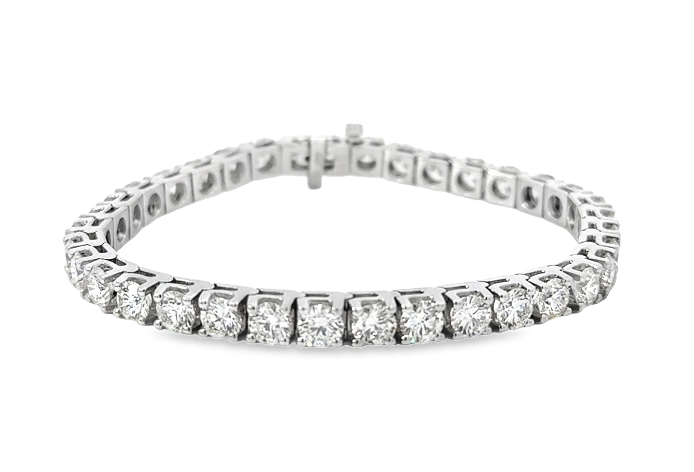 This stunning tennis bracelet features 12.94 carats of round brilliant diamonds set in 14K white gold. A bold, timeless statement of elegance.-14k White gold-Diamonds, 12.94cts-Length 7"Item# 002-170-01034 Diamond Tennis Bracelet