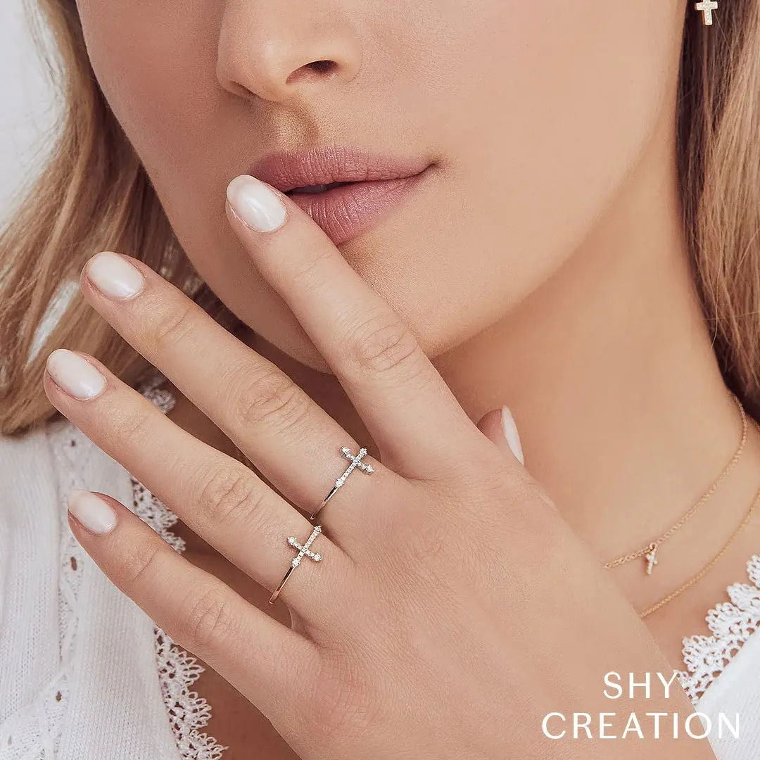 Featuring a timeless design, this piece is perfect for stacking or wearing solo for a subtle statement. All Shy Creation diamonds are natural and hand-selected. All stones are unique and hand set. As a result, you can expect slight variations in the shade, hue, tint of the color stones and stone count.-14k Yellow gold-Round diamonds, 0.09cts-Size 7Item# 804-00828 Diamond Cross Ring