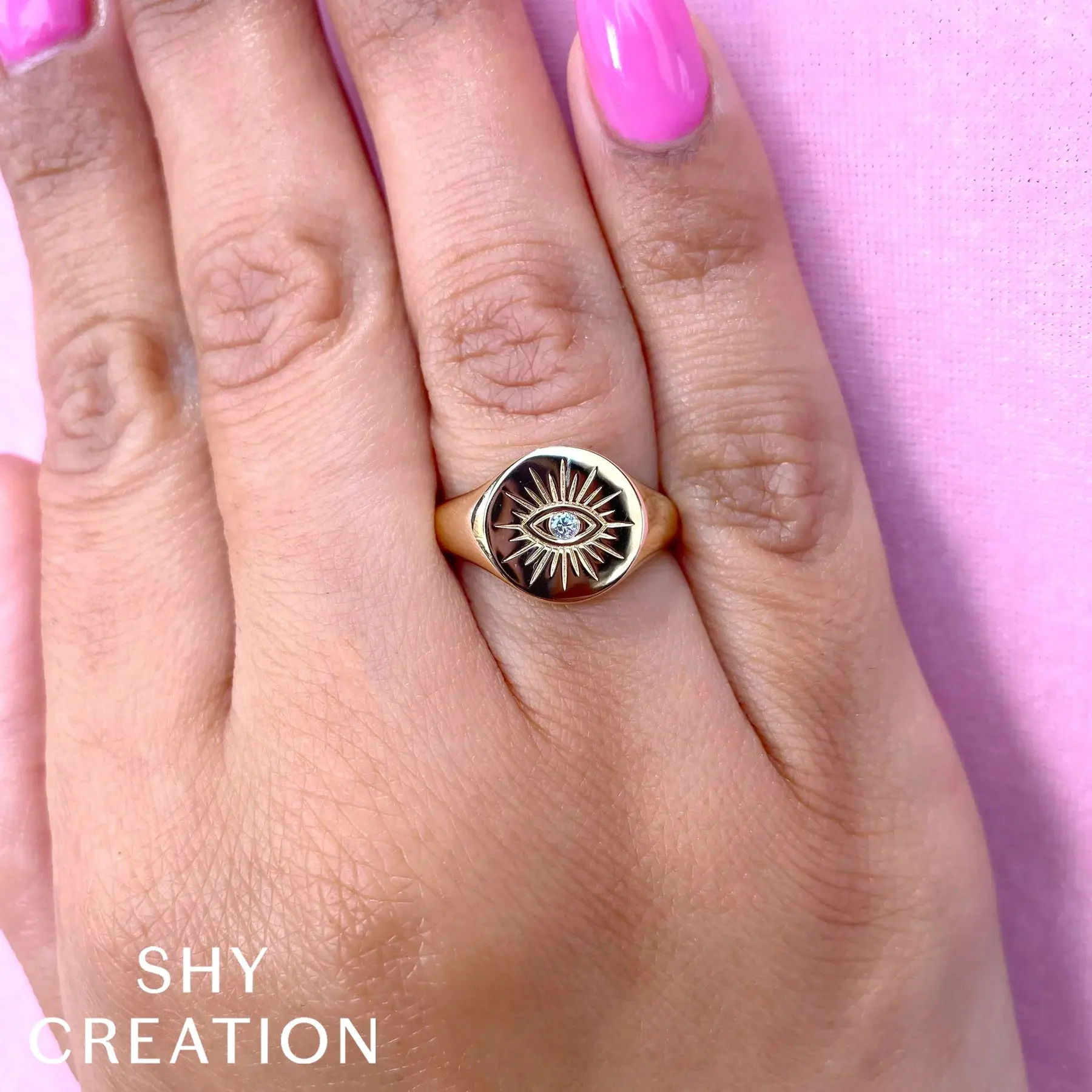 A versatile piece that complements any look, transitioning effortlessly from day to night with ease. All Shy Creation diamonds are natural and hand-selected. All stones are unique and hand set. As a result, you can expect slight variations in the shade, hue, tint of the color stones and stone count.-14k Yellow gold-Round diamond, 0.03ct-Size 7Item# 804-2000011 Diamond Eye Signet Ring