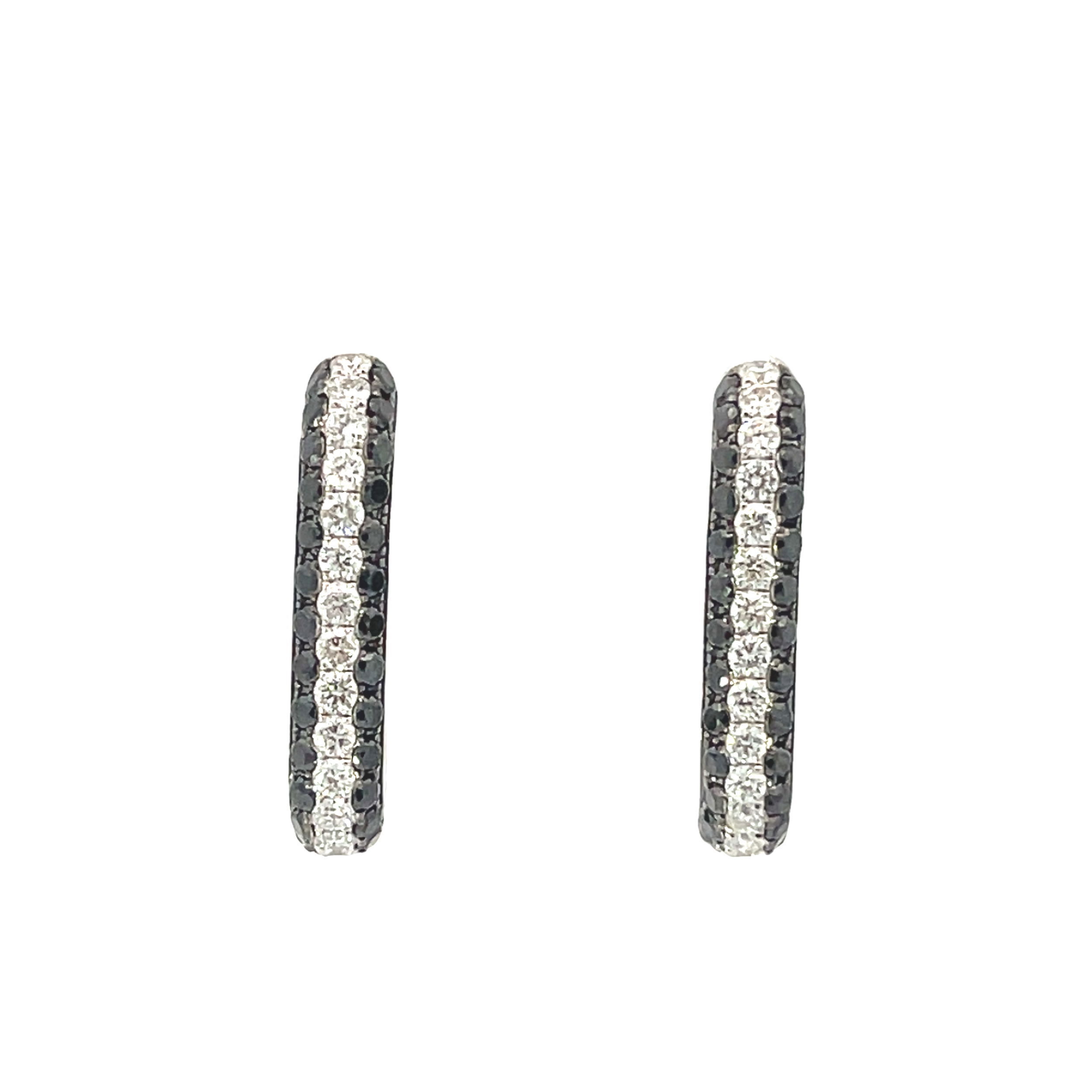Edgy black diamonds merge with classic white diamonds in a cool, slightly square silhouette. Take your all black ensemble up a notch with these medium sized hoops that are perfect for day and night. -14K White gold-Round white diamonds, 0.57cts-Round black diamonds, 0.84ctsItem# 805-01712 Black Diamond Hoops