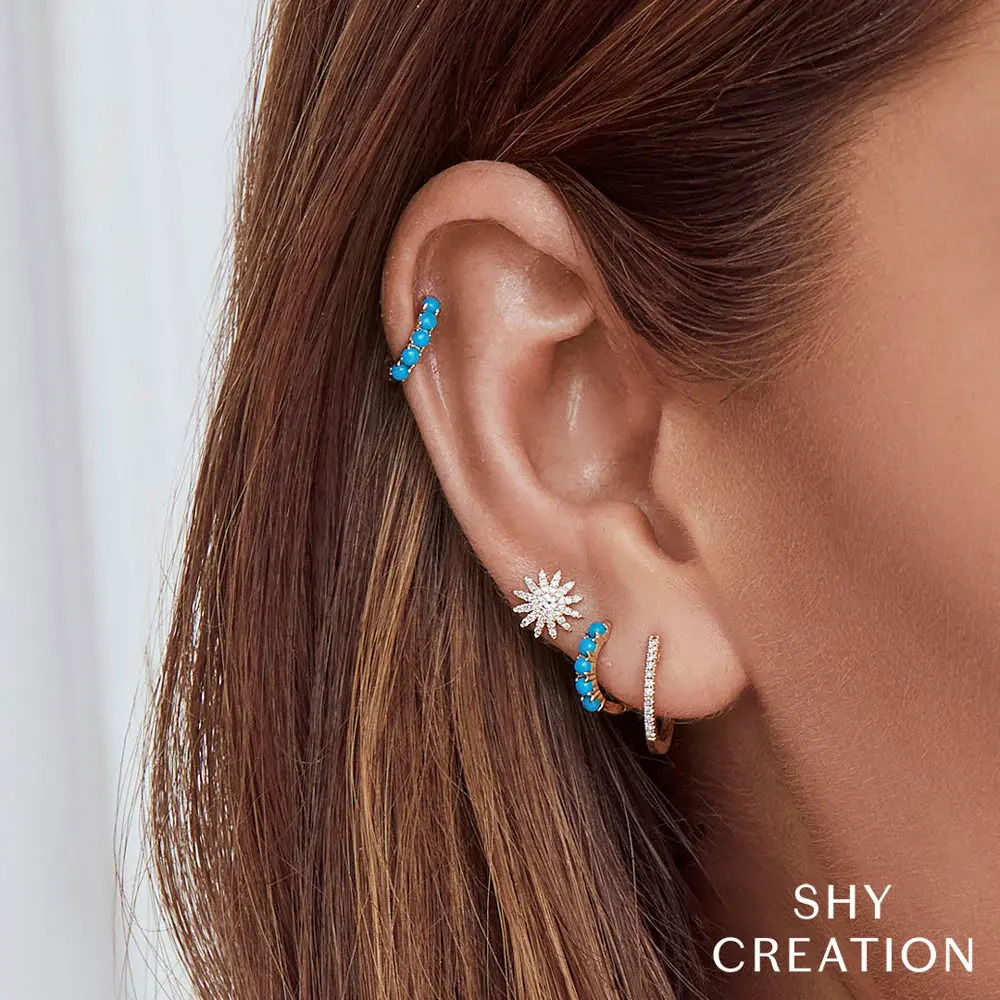 Seamlessly blend this elegant piece with your favorite pieces for a look that is both refined and effortless. Shy Creation diamonds are natural and hand-selected. All stones are unique and hand set. As a result, you can expect slight variations in the shade, hue, tint of the color stones and stone count. -14k Yellow gold-Round turquoise, 0.43cts-Dimensions, 0.40"L / 0.10"WItem# 805-2000126 Composite Turquoise Huggie Earrings