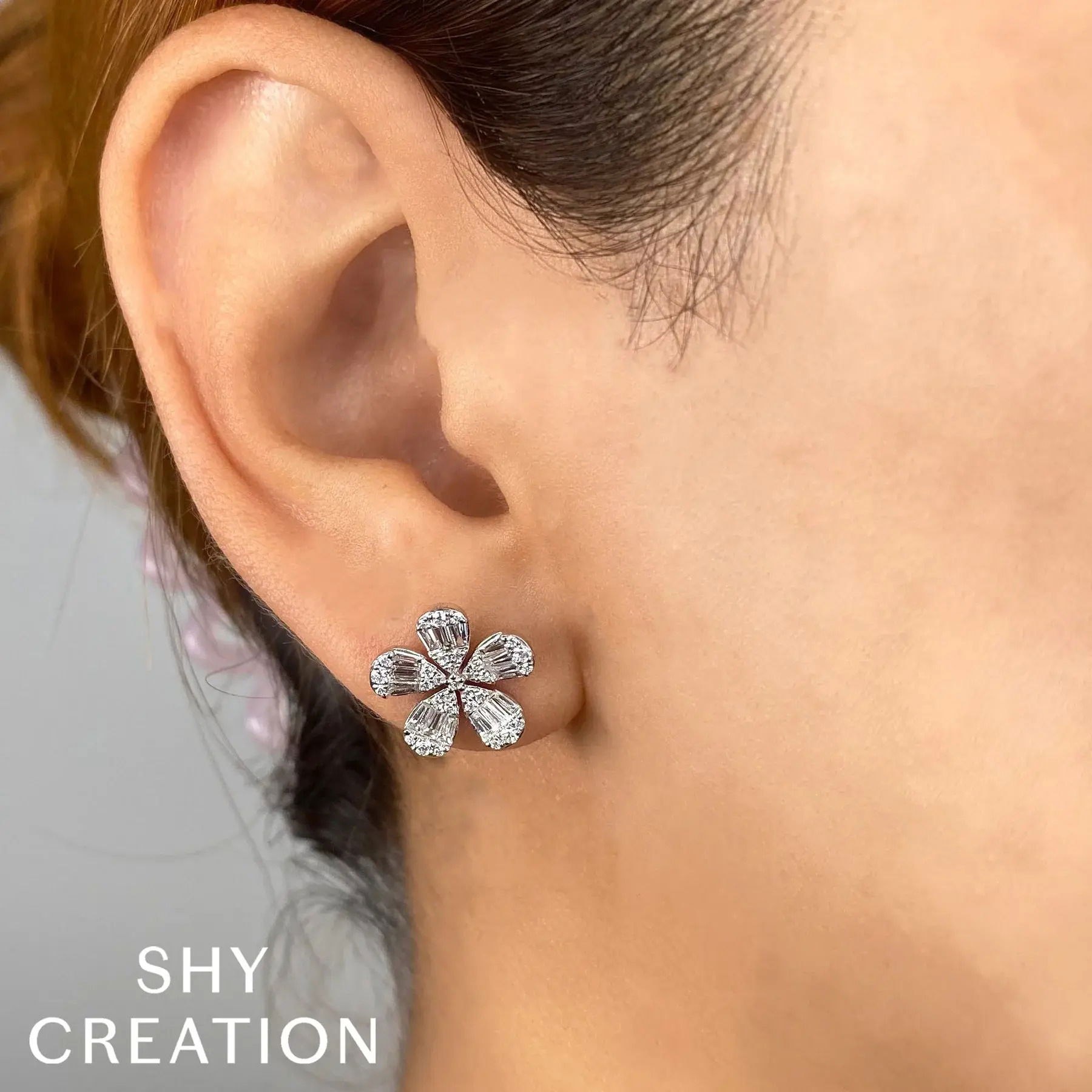 A beautiful accent piece or a stunning stand alone, this piece is the ideal addition to any collection. All Shy Creation diamonds are natural and hand-selected. All stones are unique and hand set. As a result, you can expect slight variations in the shade, hue, tint of the color stones and stone count.-14k Yellow gold-Round diamonds, 0.32cts-Baguette diamonds, 0.68cts-Dimensions, 0.55"L / 0.55"WItem# 805-2000216 Diamond Baguette Flower Stud Earrings