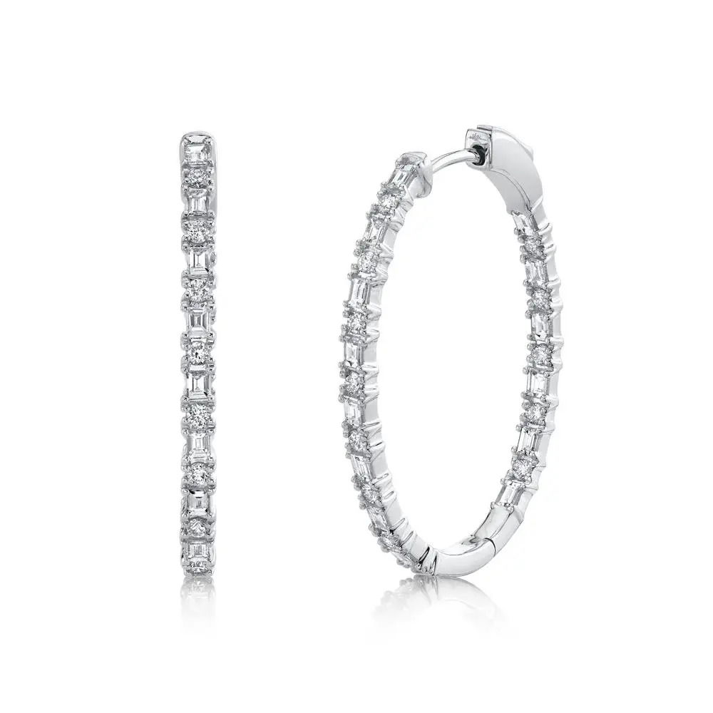 Command attention with the bold and striking design of this piece, perfect for making a lasting impression. Shy Creation diamonds are natural and hand-selected. All stones are unique and hand set. As a result, you can expect slight variations in the shade, hue, tint of the color stones and stone count.-14k White gold-Baguette diamonds, 0.83cts-Oval diamonds, 0.43cts-Dimensions, 1.25" x 0.90" diameterItem# 805-2000219 Diamond Baguette Oval Hoop Earrings