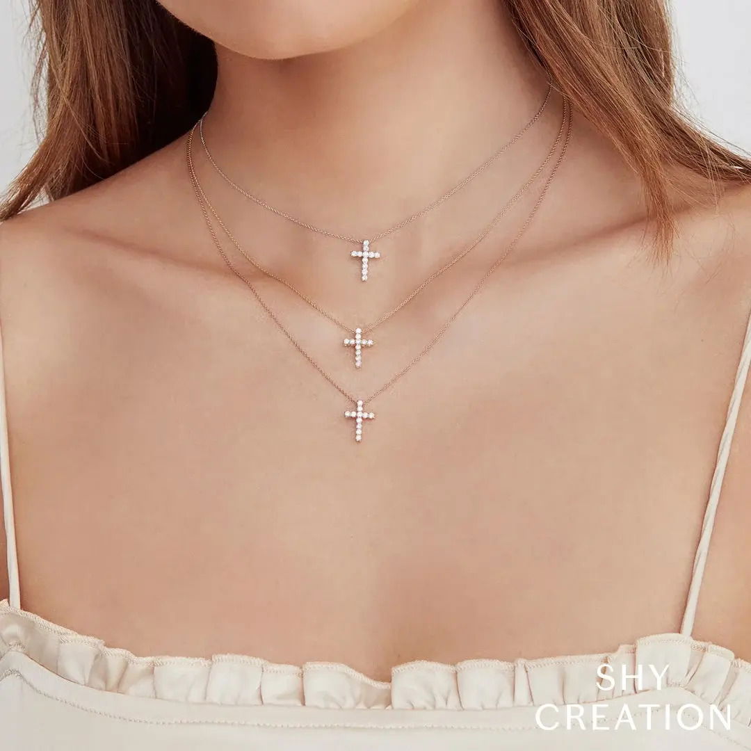 This timeless necklace is the perfect finishing touch to any ensemble. All Shy Creation diamonds are natural and hand-selected. All stones are unique and hand set. As a result, you can expect slight variations in the shade, hue, tint of the color stones and stone count.-14k Yellow gold-Round diamonds, 0.32cts-Dimensions, 0.55"L / 0.40"W-Chain length, 15"-18"Item# 807-01227 Diamond Cross Necklace