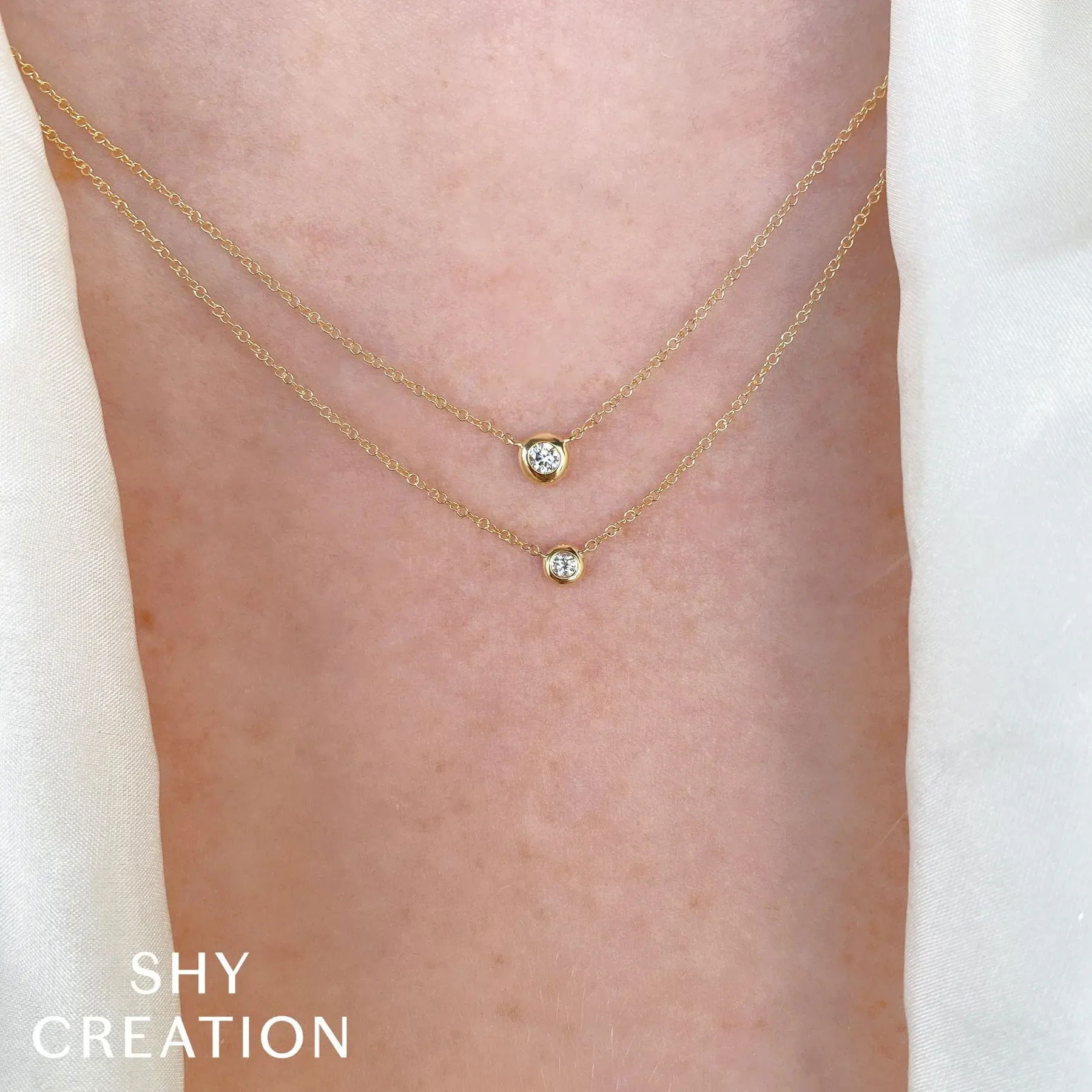 Enjoy a piece that combines standout style with all-day comfort, making it perfect for any occasion. All Shy Creation diamonds are natural and hand-selected. All stones are unique and hand set. As a result, you can expect slight variations in the shade, hue, tint of the color stones and stone count.-14k White gold-Round diamond, 0.05cts-Chain length, 15"-18" on adjustable chainItem# 807-2000017 Diamond Bezel Necklace