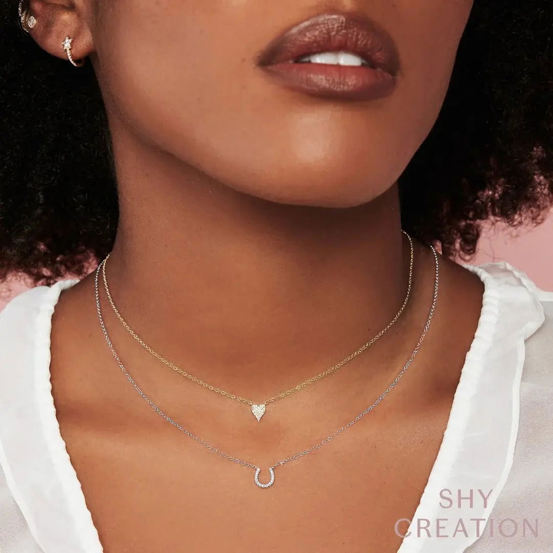 A beautiful accent piece or a stunning stand alone, this piece is the ideal addition to any collection. All Shy Creation diamonds are natural and hand-selected. All stones are unique and hand set. As a result, you can expect slight variations in the shade, hue, tint of the color stones and stone count.-14k White gold-Round diamonds, 0.06cts-Chain length, 15"-18"-Dimensions, 0.30"L / 0.30"WItem# 807-2000120 Diamond Horseshoe Necklace