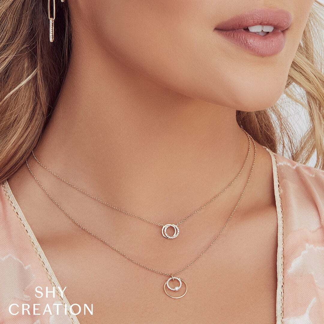 A perfect piece to add a touch of sparkle to any casual or formal outfit. Shy Creation diamonds are natural and hand-selected. All stones are unique and hand set. As a result, you can expect slight variations in the shade, hue, tint of the color stones and stone count.-14k Yellow gold-Round diamonds, 0.07cts-Chain length, 15"-18"Item# 807-2000128 Diamond Love Knot Circle Necklace