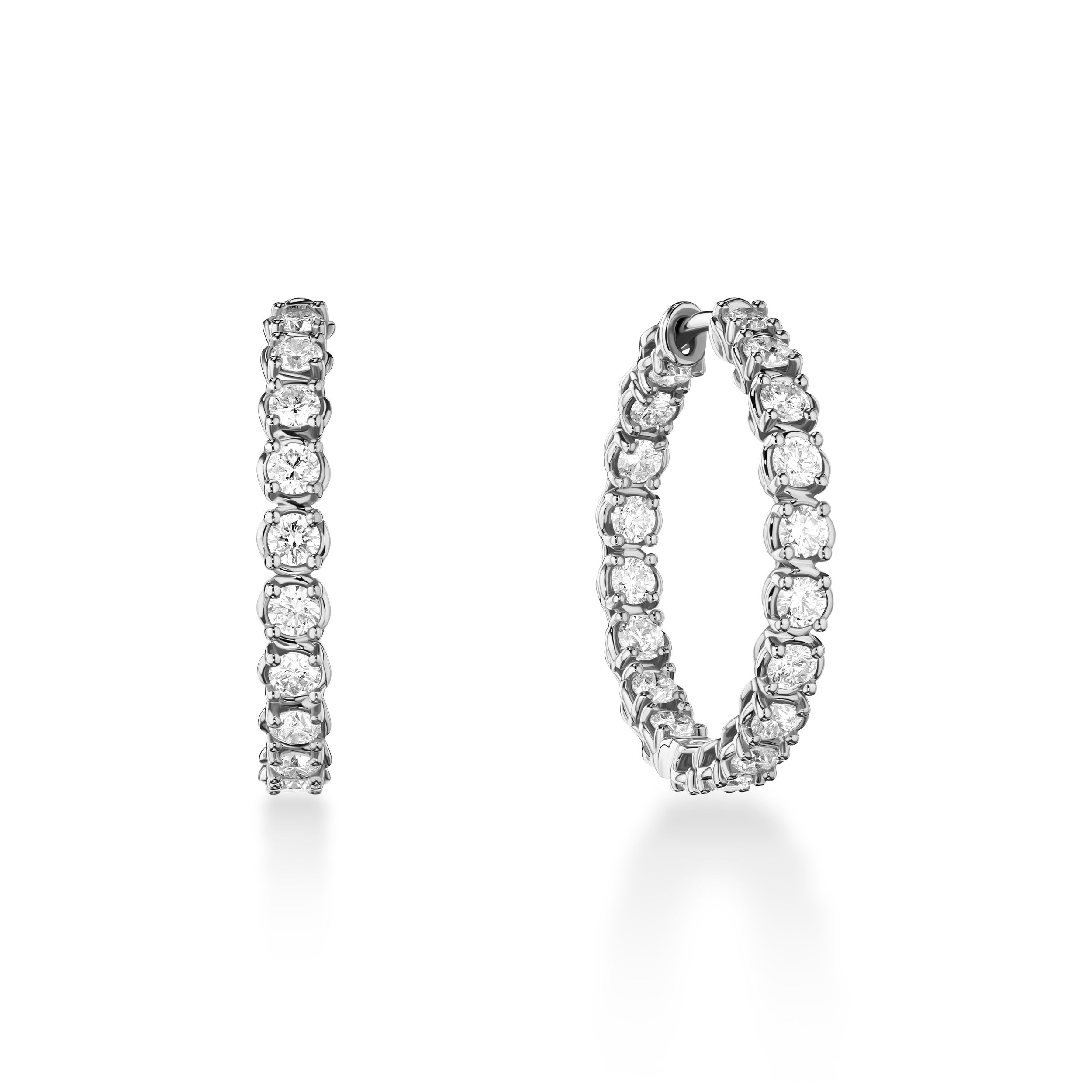 These inside-out diamond hoop earrings bring modern elegance to a timeless style. Set in a unique twisted faux bezel and prong design, each diamond is perfectly positioned to catch the light from every angle. Sophisticated yet distinctive, these hoops make a refined statement for any occasion. -18k white gold-Round diamonds, 2.09ctsItem #: 150-01903 Inside Out Hoops