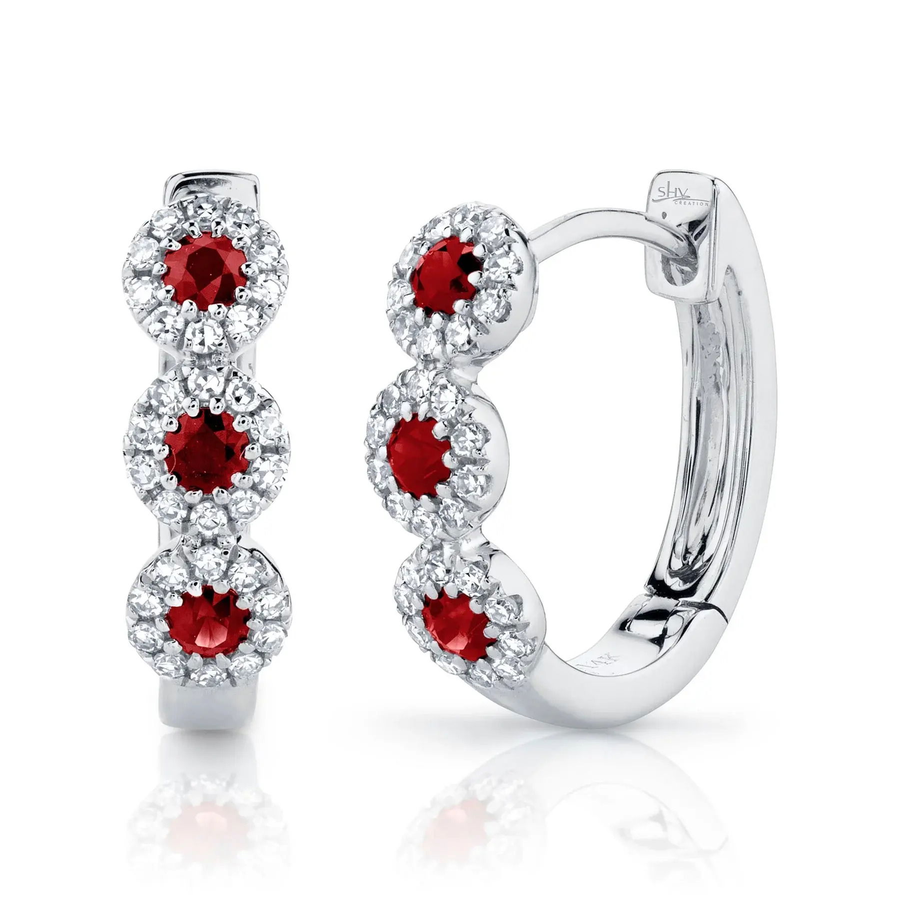 A unique and stylish accessory that adds a touch of flair to any gathering or special occasion. All Shy Creation diamonds are natural and hand-selected. All stones are unique and hand set. As a result, you can expect slight variations in the shade, hue, tint of the color stones and stone count.-14k White gold-Ruby, 0.29cts-Round diamonds, 0.15cts-Dimensions, 0.55"L / 0.15"WItem# 805-2000229 Diamond and Ruby Huggie Earrings