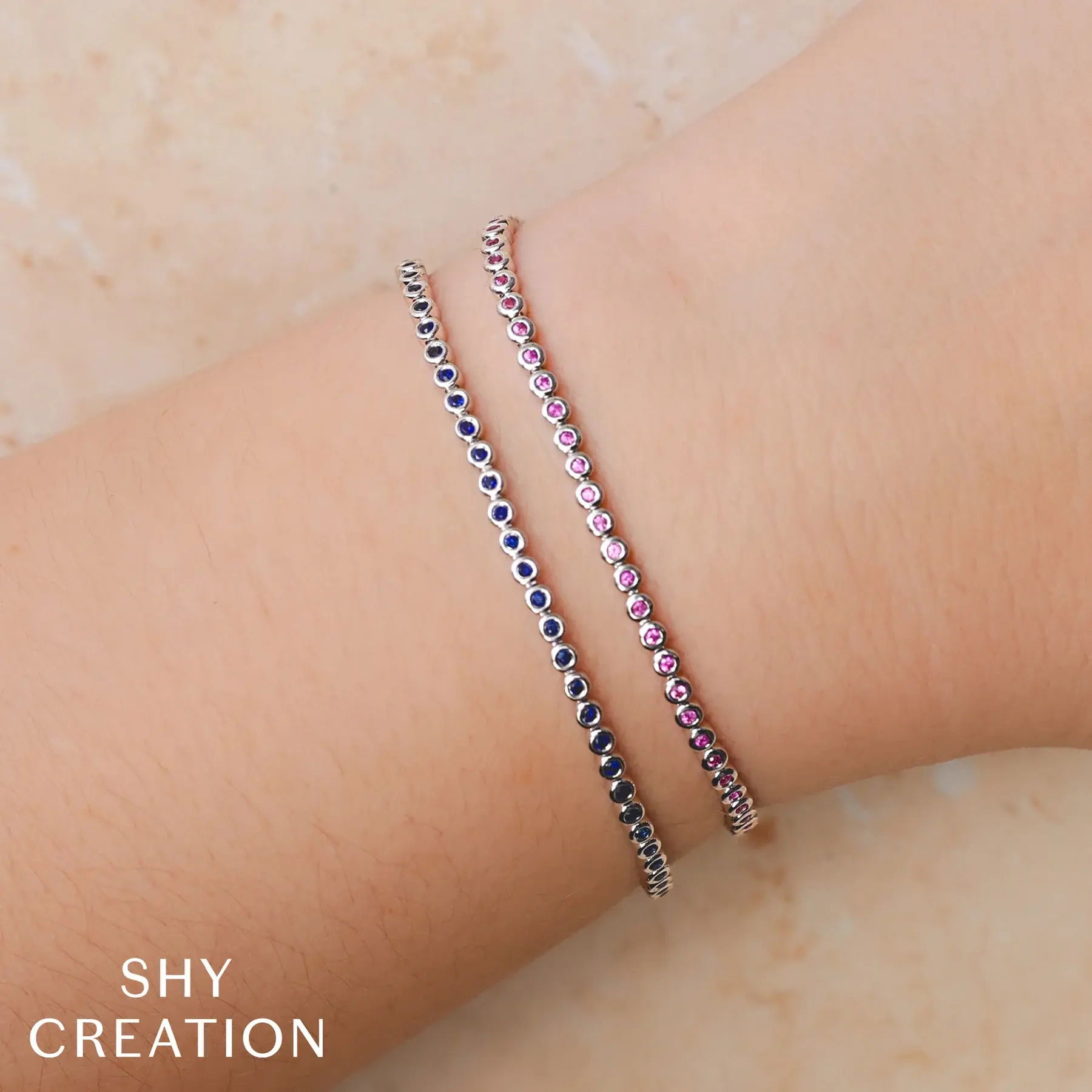 Sleek yet captivating, this minimalist piece is designed to draw attention. The stones are in a bezel setting for everyday wear. -14k White gold-Round blue sapphires, 0.80ctsItem# 808-2000124 Blue Sapphire Bezel Tennis Bracelet