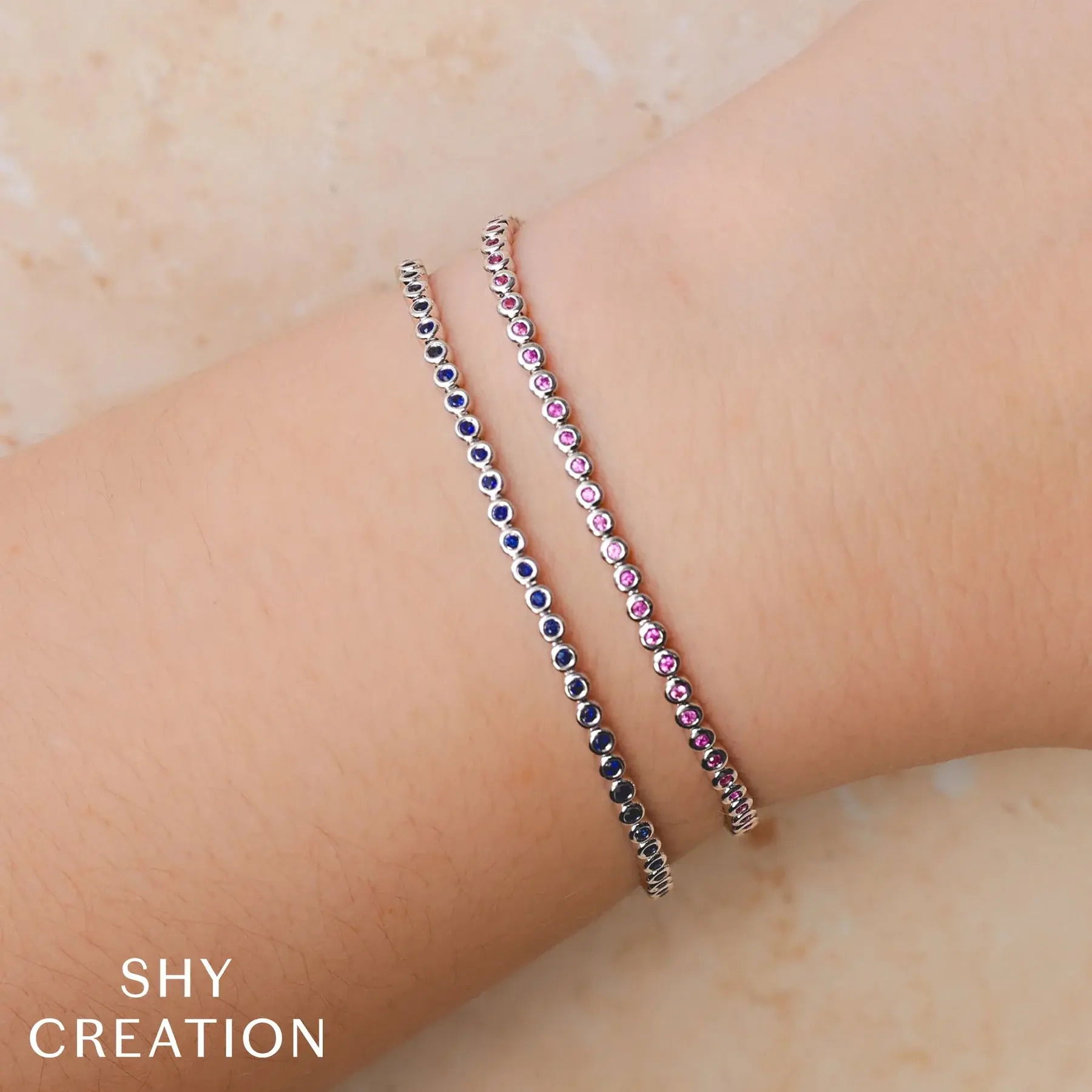This versatile piece is the ideal accent piece or statement on its own, perfect for any collection. The stones are set in a sleek bezel setting for everyday wear. -14k Yellow gold-Round pink sapphires, 0.80ctsItem# 808-2000126 Pink Sapphire Tennis Bracelet