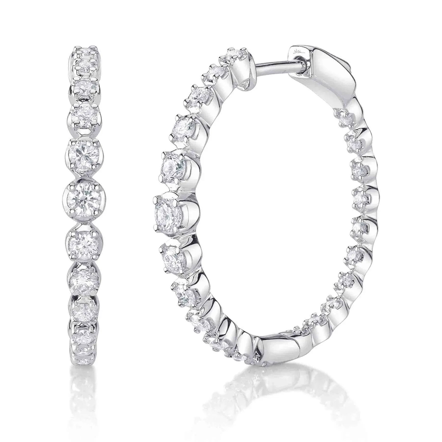 Stand out effortlessly with a design that turns heads at any event, making you the center of attention. All Shy Creation diamonds are natural and hand-selected. All stones are unique and hand set. As a result, you can expect slight variations in the shade, hue, tint of the color stones and stone count.-14k White gold-Round diamonds, 0.5ctsItem# 805-2000253 Diamond Crown Setting Hoop Earrings