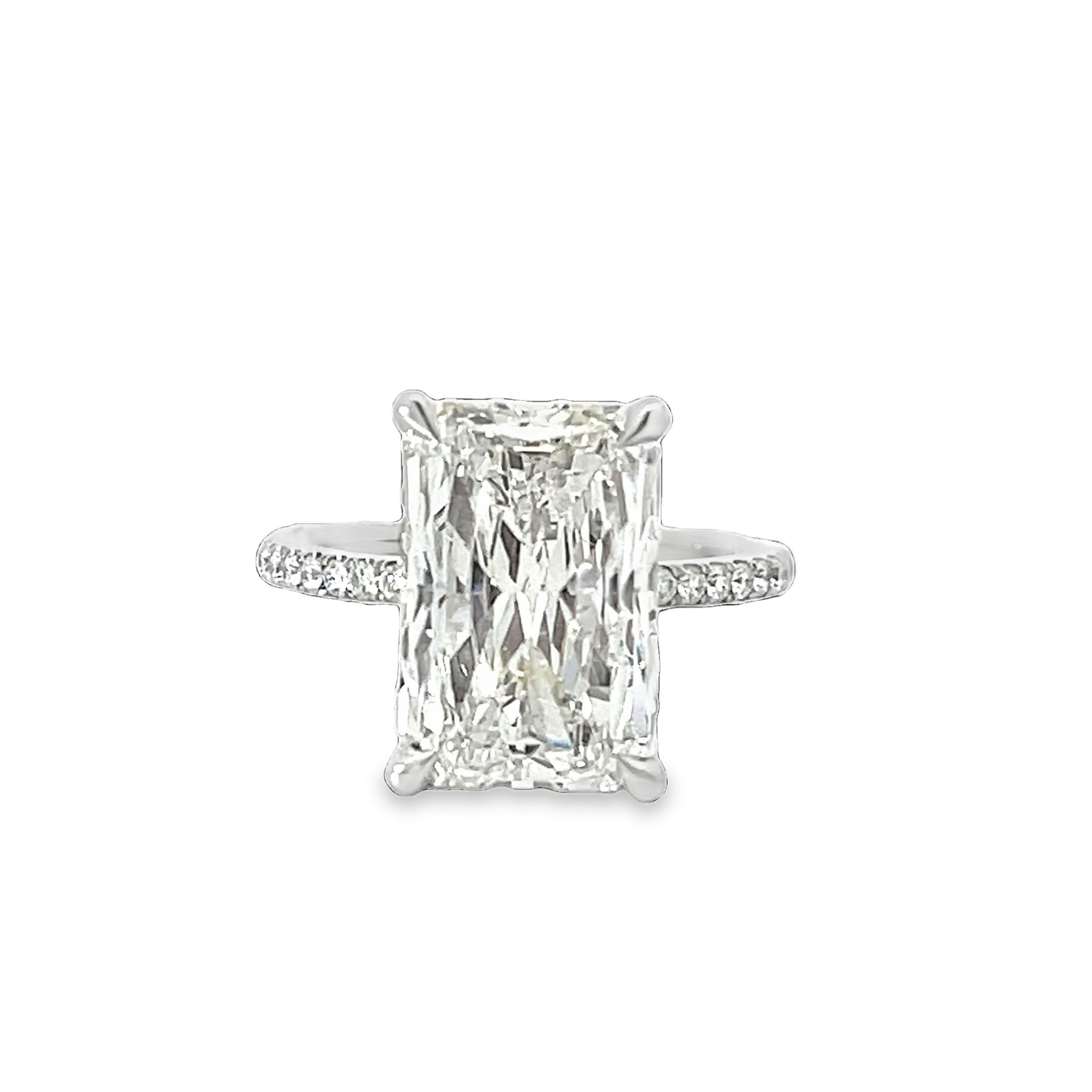 A masterpiece of elegance and emotion, this solitaire features a stunning 7.03 carat radiant cut diamond. Its captivating brilliance and bold presence are matched only by the love it represents—extraordinary, enduring, and entirely unforgettable.-Platinum-Radiant diamond, 7.03ct-Round diamonds, 0.74cts-Size 6.5, Contact for sizing optionsItem# 100-2000013 Micro Pave Engagement Ring