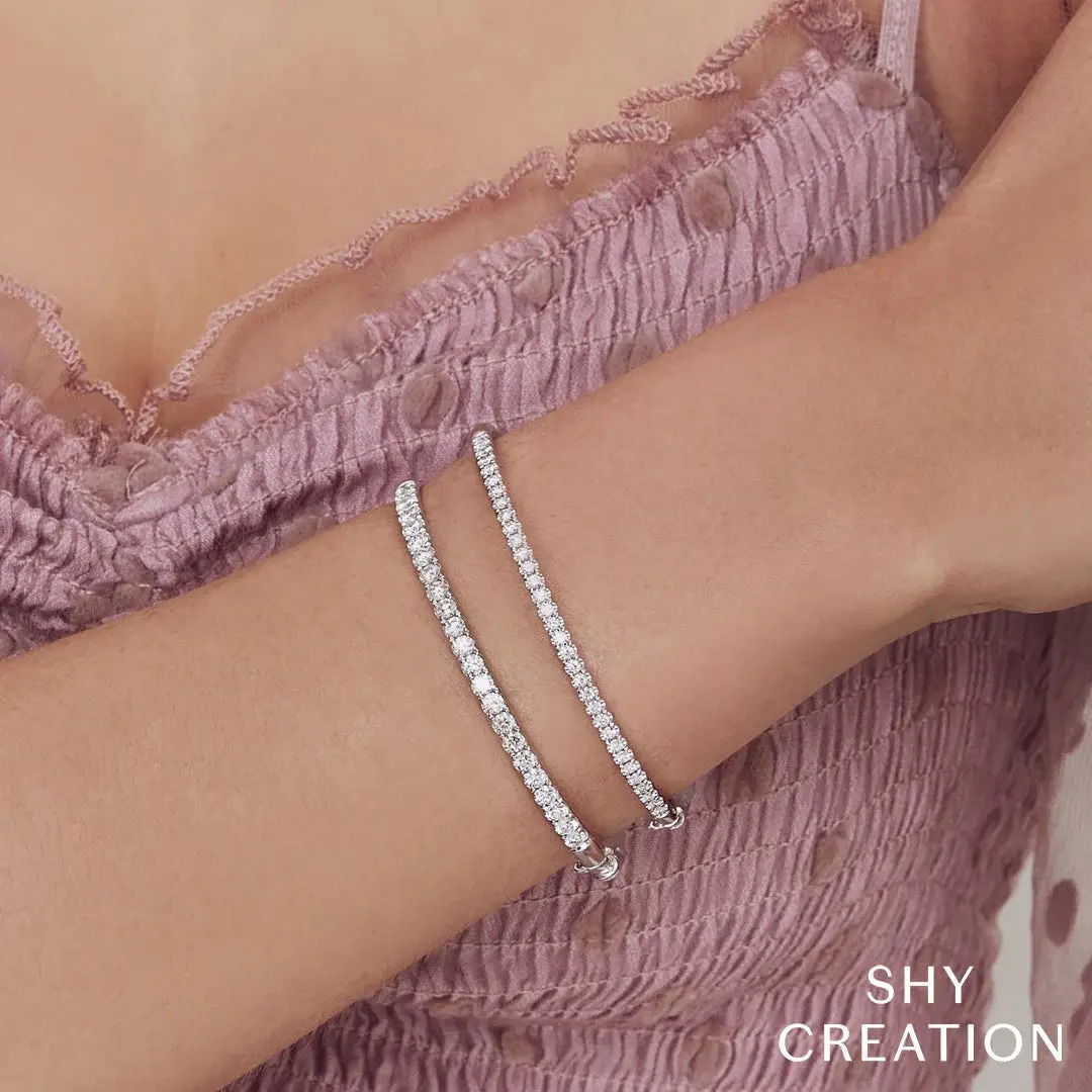 Effortless elegance that suits both casual days and sophisticated evenings. All Shy Creation diamonds are natural and hand-selected. All stones are unique and hand set. As a result, you can expect slight variations in the shade, hue, tint of the color stones and stone count.-14k White gold-Round diamonds, 2.00cts-Size SItem# 808-2000133 Diamond Bangle