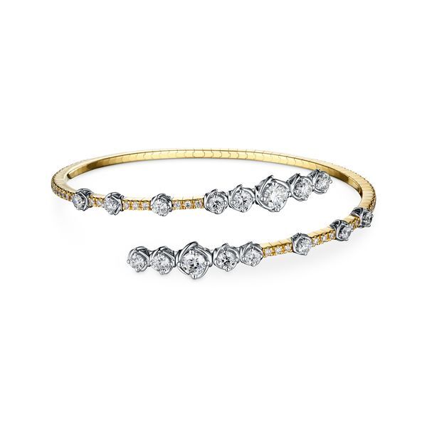 Elegance meets modern design in this diamond bypass bracelet, featuring a sleek twist bezel setting that enhances each diamond’s brilliance. The graceful bypass style adds a touch of movement, making this piece a timeless statement of sophistication.-18k Two tone gold-Round diamonds, 3.07ctsItem# 170-2000016 Bypass Bangle