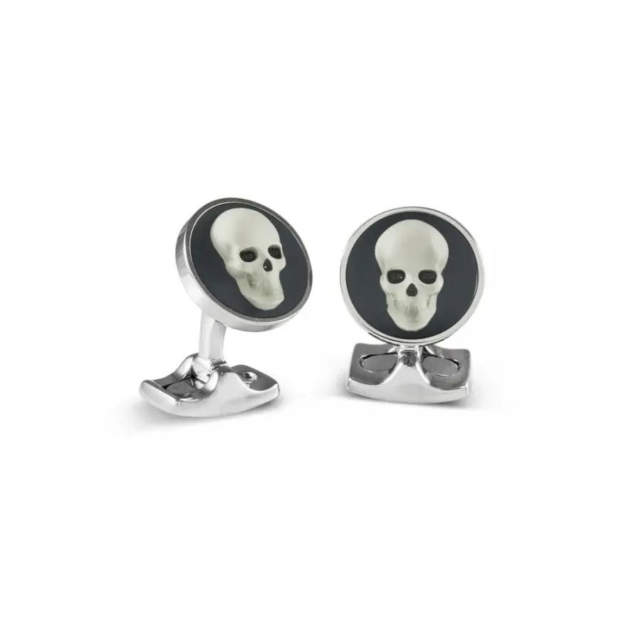 These Deakin & Francis Skull Cameo cufflinks feature intricately detailed skull motifs in stunning cameo relief, beautifully set against polished sterling silver backings for a refined yet daring aesthetic. Handcrafted in England, each piece merges artisanal heritage with bold contemporary flair, perfect for the modern gentleman seeking standout elegance.-Sterling silver-Item# 800-2000018 Skull Cameo Cufflinks